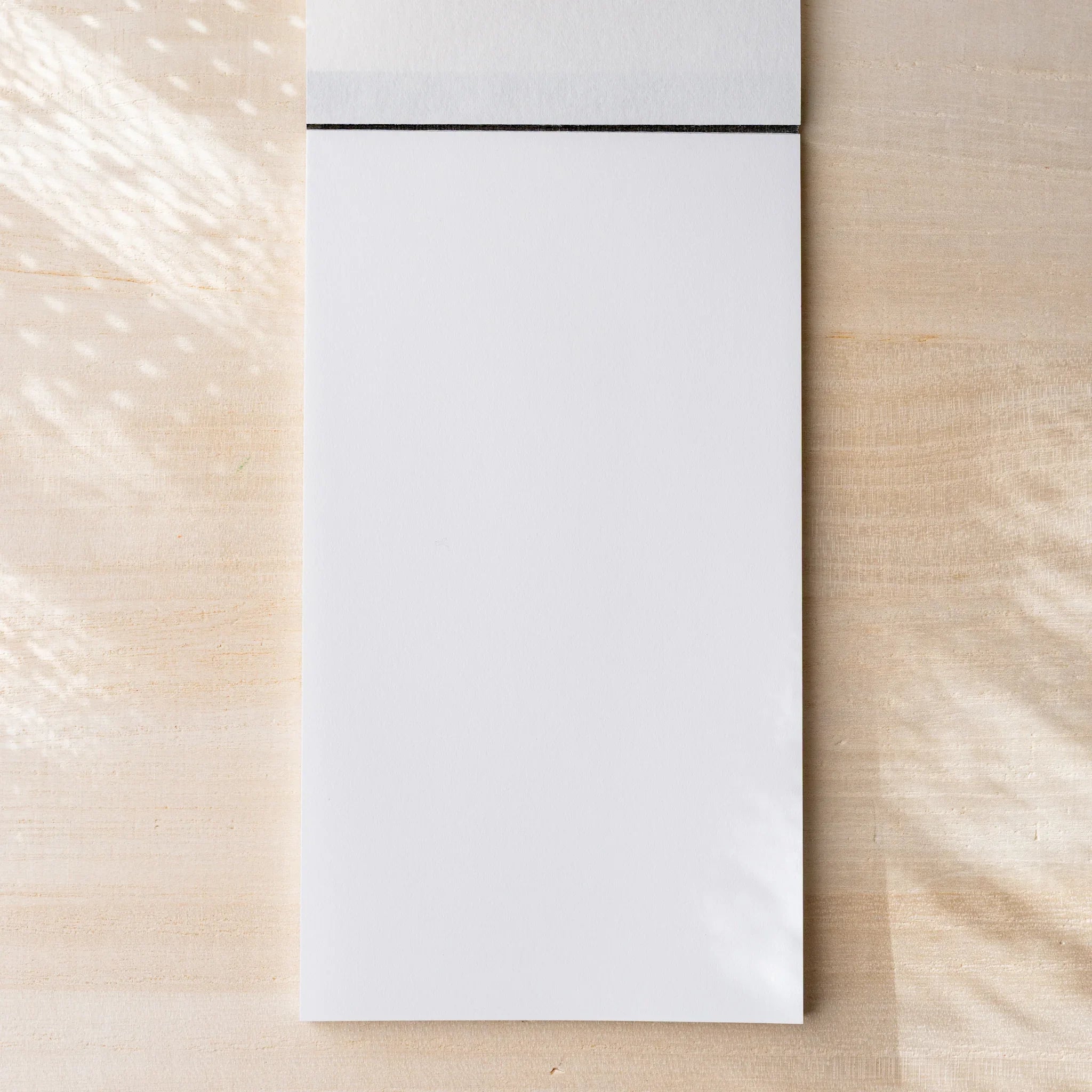 Yamamoto Paper Canopus Bullet Paper No.2 notepad opened to first blank sheet with top cloth binding.