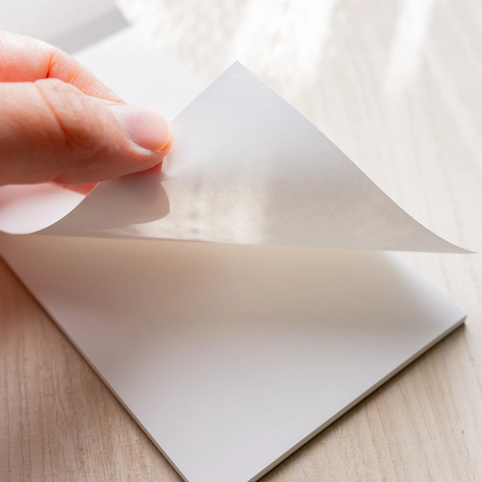 Hand peeling a translucent 52gsm sheet from Yamamoto Paper Sanzen Tomoe River S Bullet Paper No.1 notepad.