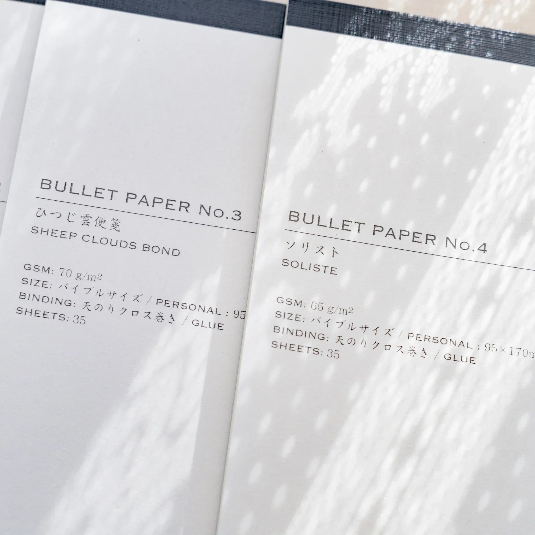 Close-up of Yamamoto Paper Bullet Paper No.3 Sheep Clouds Bond and No.4 Soliste paper notepad covers.
