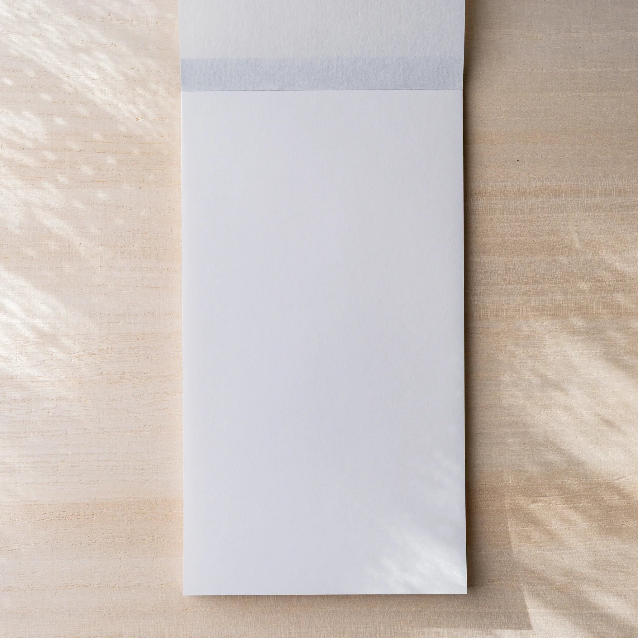 Yamamoto Paper Sheep Clouds Bond Bullet Paper No.3 notepad opened to first blank sheet with top cloth binding.