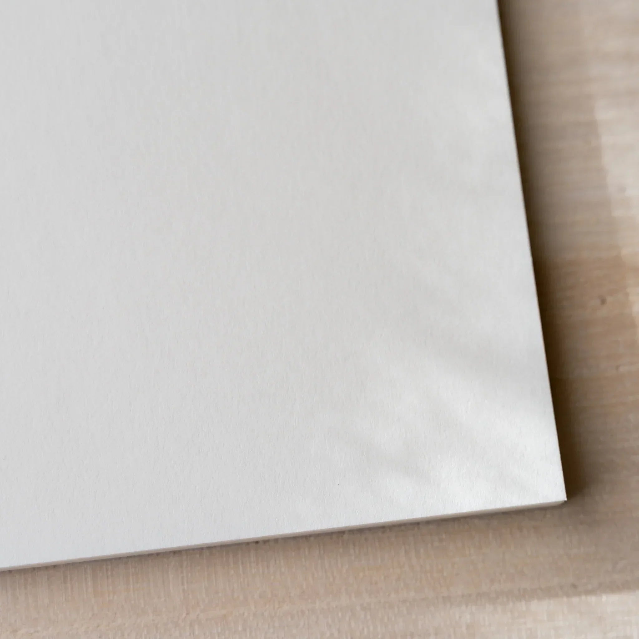 Corner close-up of Yamamoto Paper Soliste Bullet Paper No.4 cream-tinted Japanese paper stationery notepad.