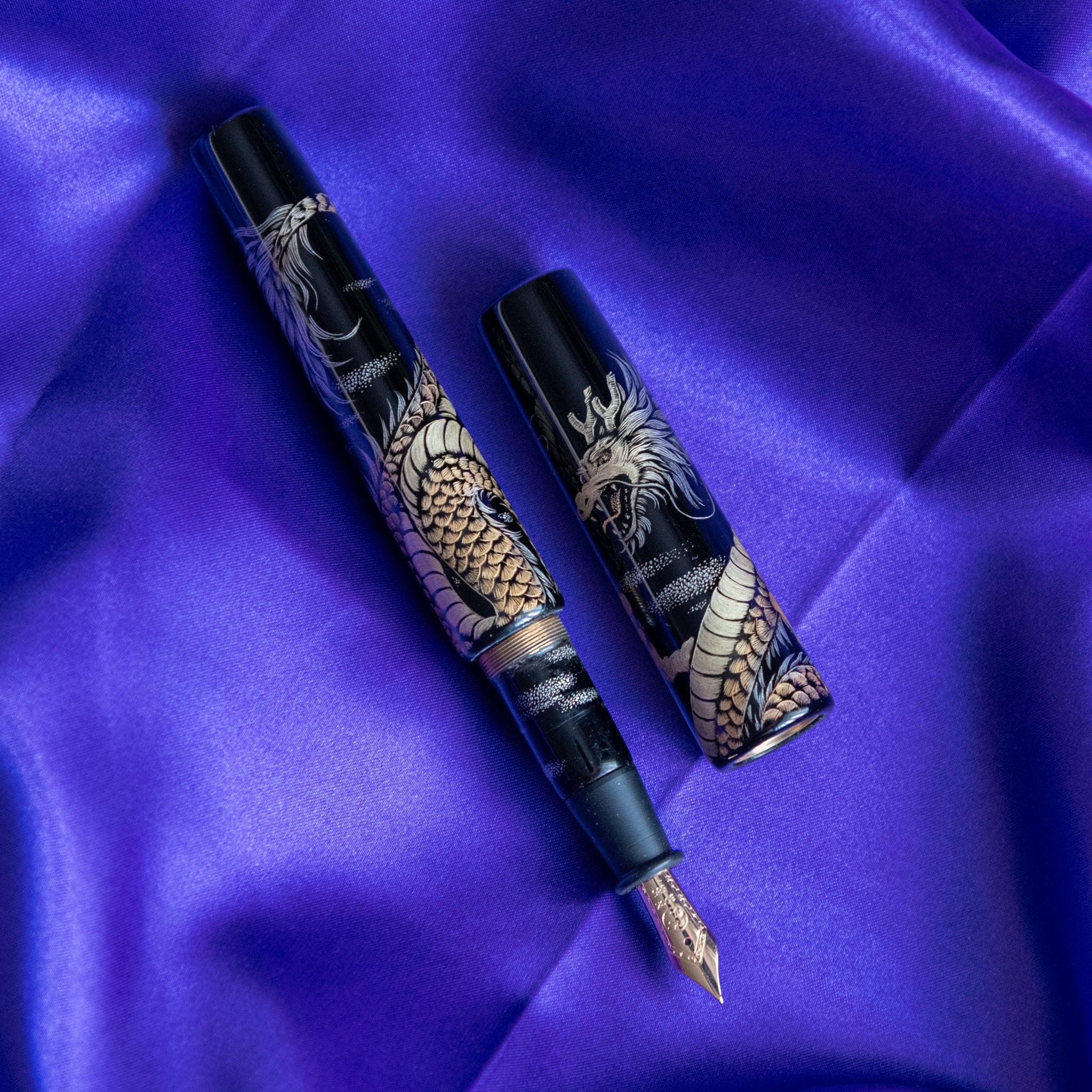 Chinkin Dragon pen positioned on Echizen washi paper with ink test marks showing product quality and design details