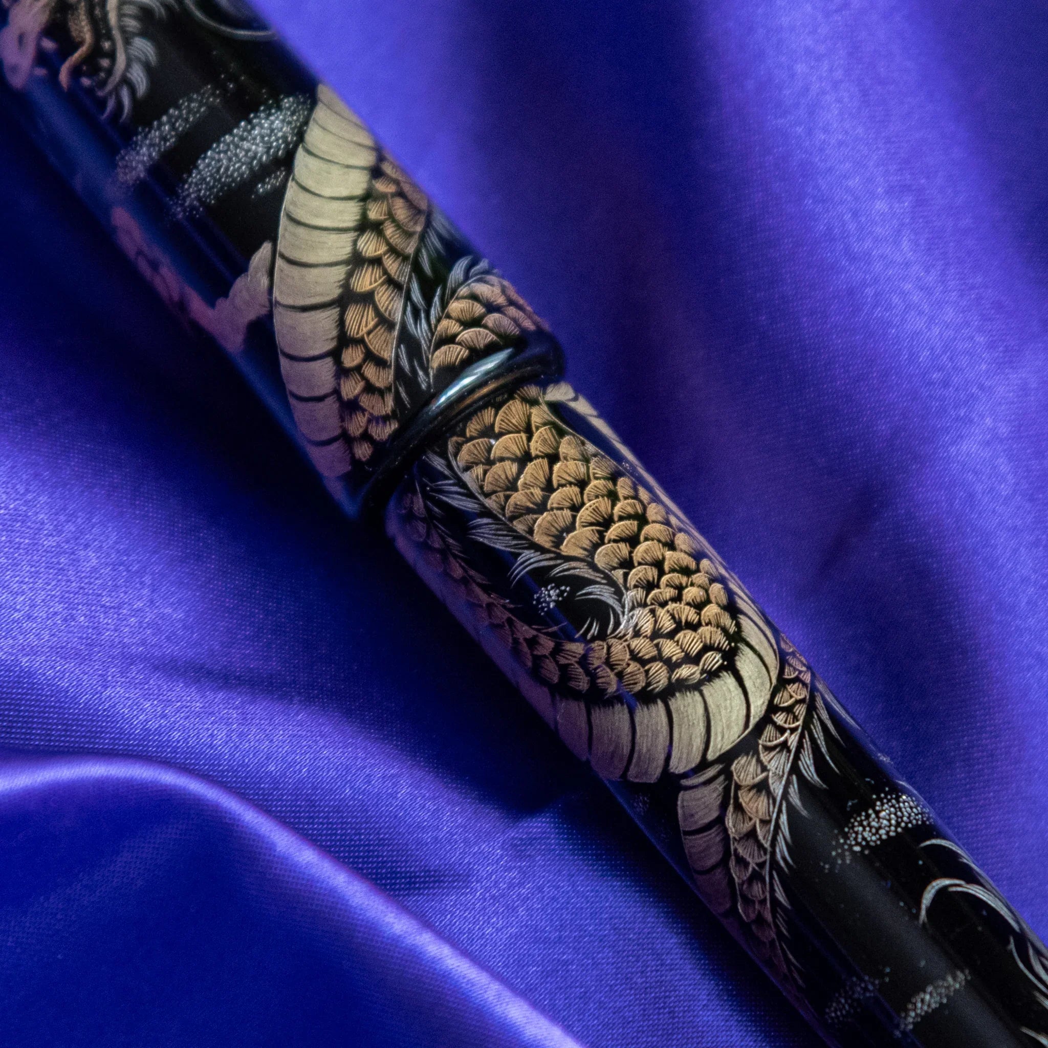 Detail shot of Chinkin Dragon pen clip and cap showing metallic trim and decoration showing product quality and design det