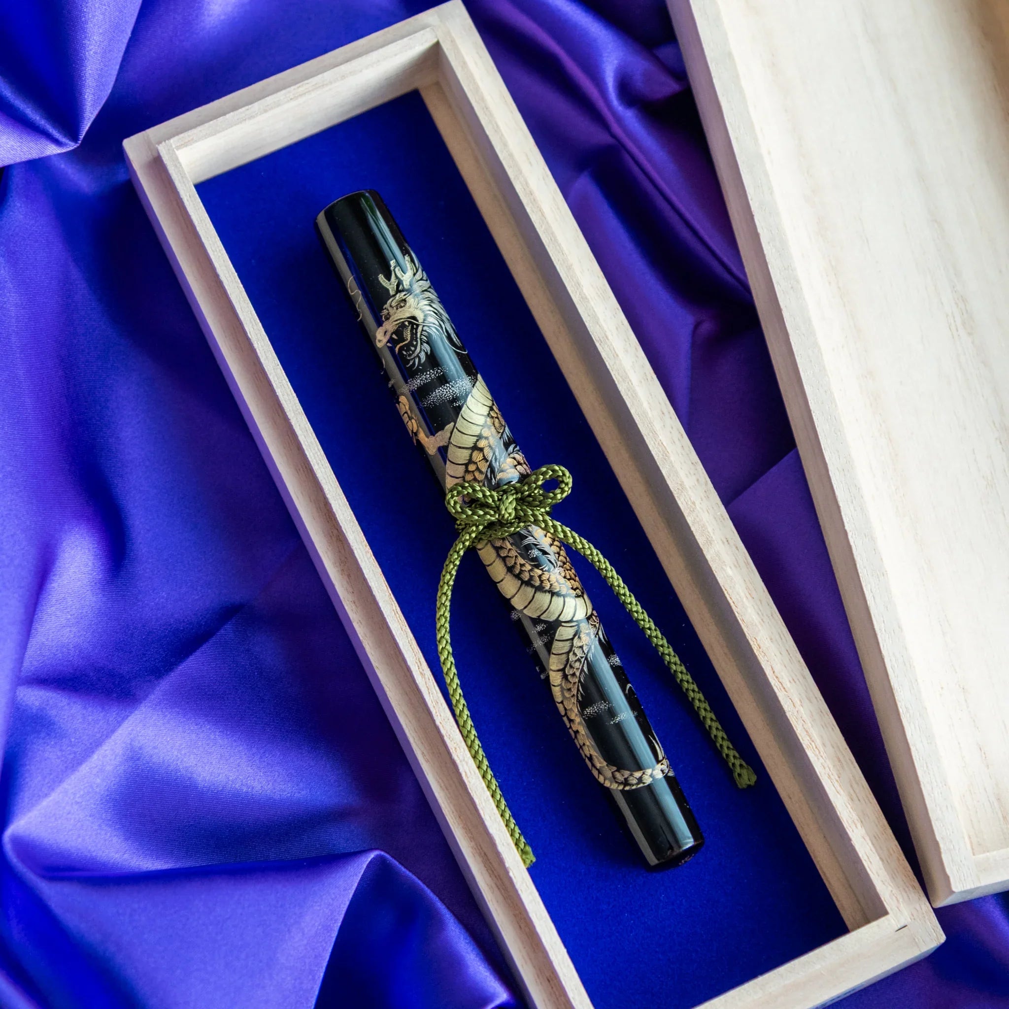 Closed wooden presentation box for Chinkin Dragon fountain pen on purple fabric showing product quality and design details