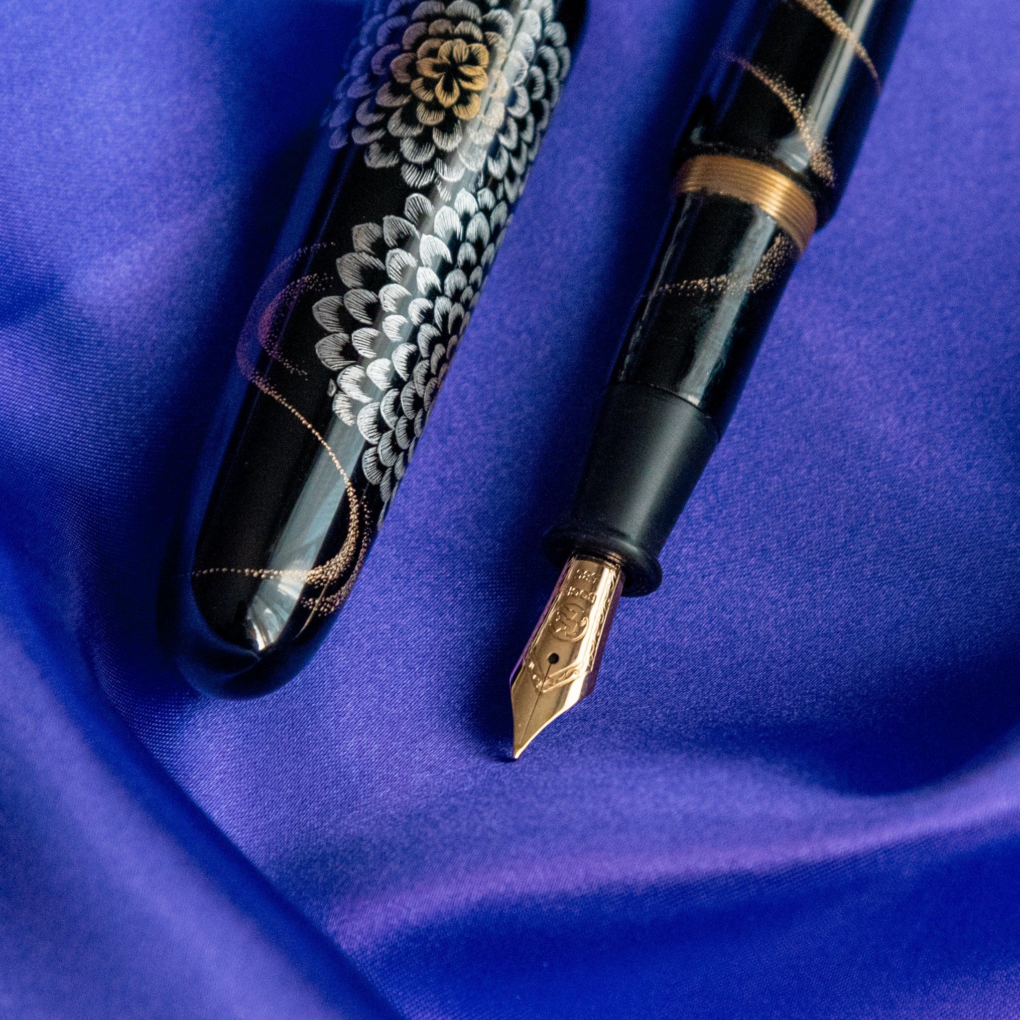 Chinkin Kikusui fountain pen positioned on coordinating washi paper showing ink flow showing product quality and design de