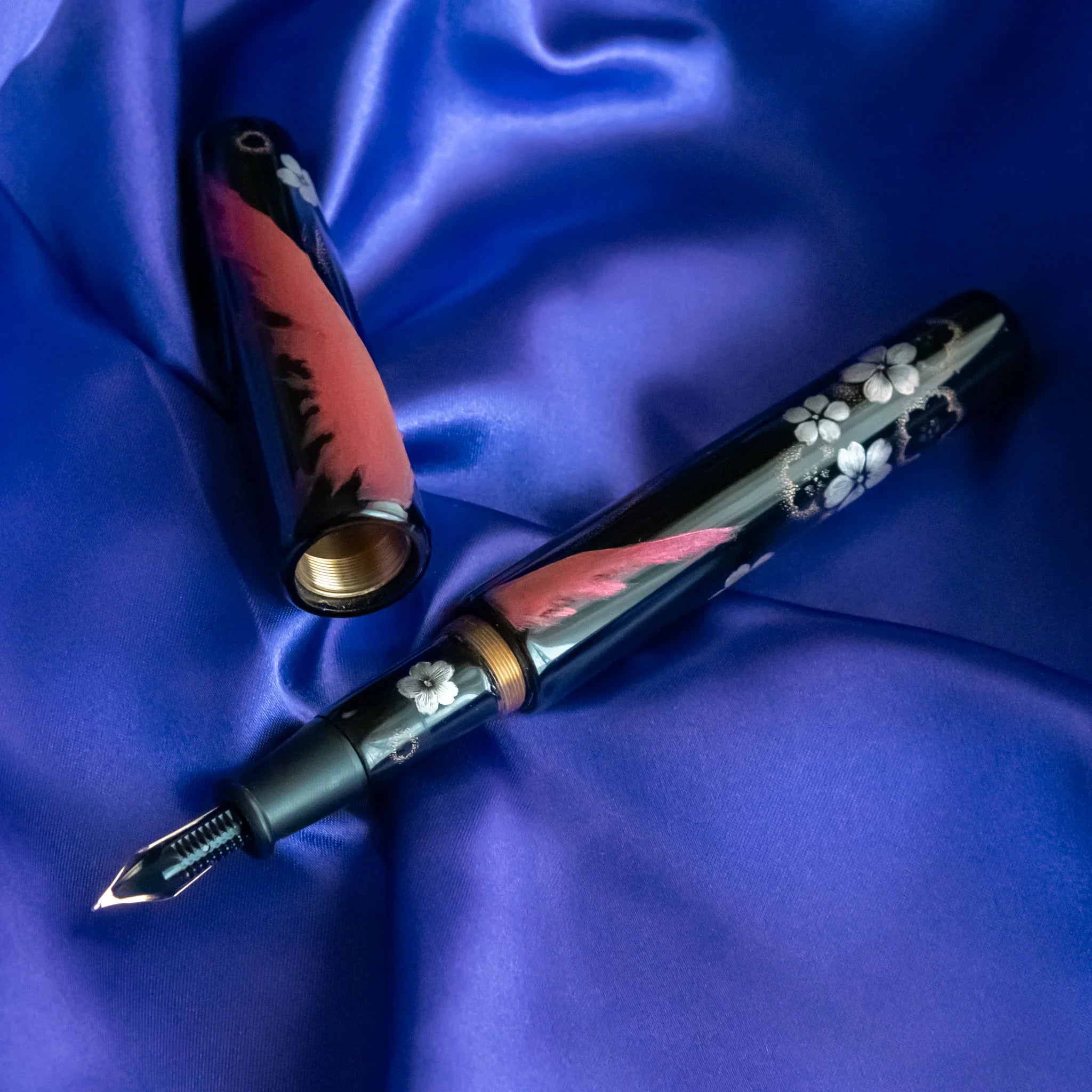 Chinkin Sakura and Fuji pen positioned on coordinating washi showing ink characteristics showing product quality and desig