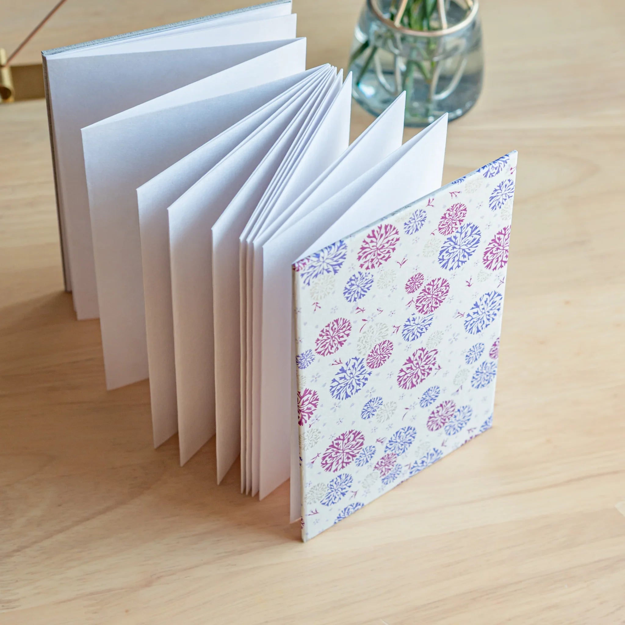 Open Chrysanthemum Harmony purple goshuincho displaying white interior pages and floral cover ready for temple stamp colle