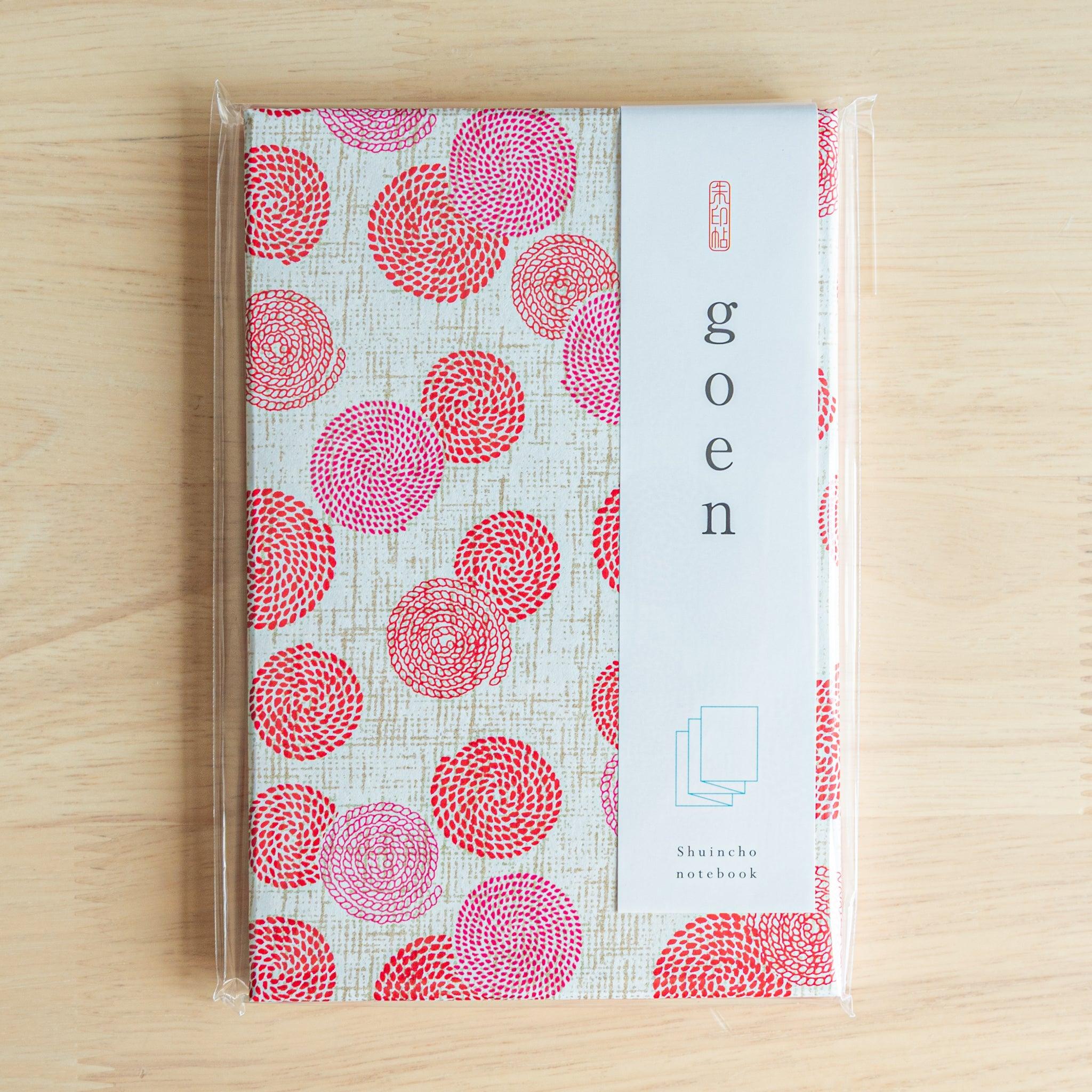 Goshuinsho stamp book with pink and red blossom swirl design, packaged and labeled “goen” as Japanese stationery.
