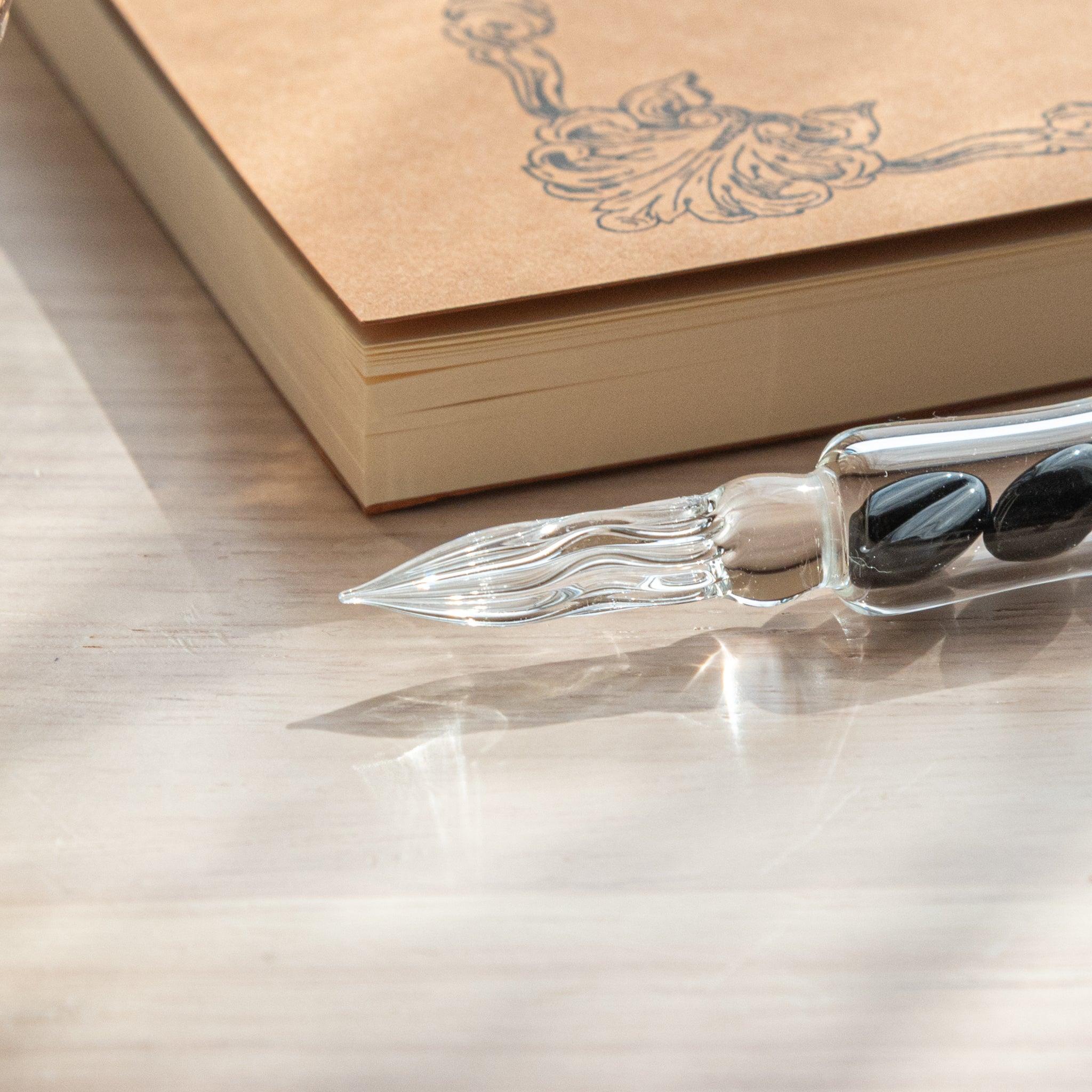 City Roast Coffee Beans Glass Dip Pen with matching coffee-themed ink cartridge and decorative notepad on wooden surface