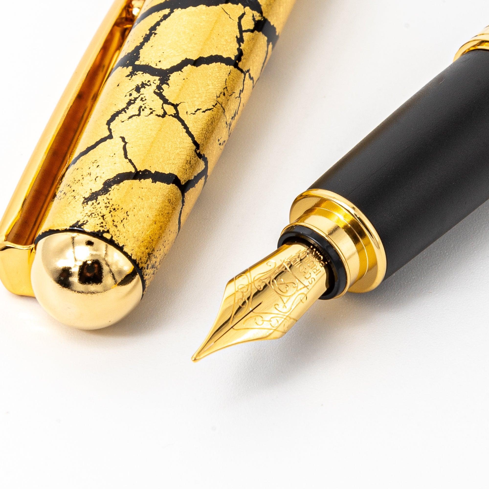 Black fountain pen at angle showing fine gold crack pattern design detail on black lacquer barrel surface