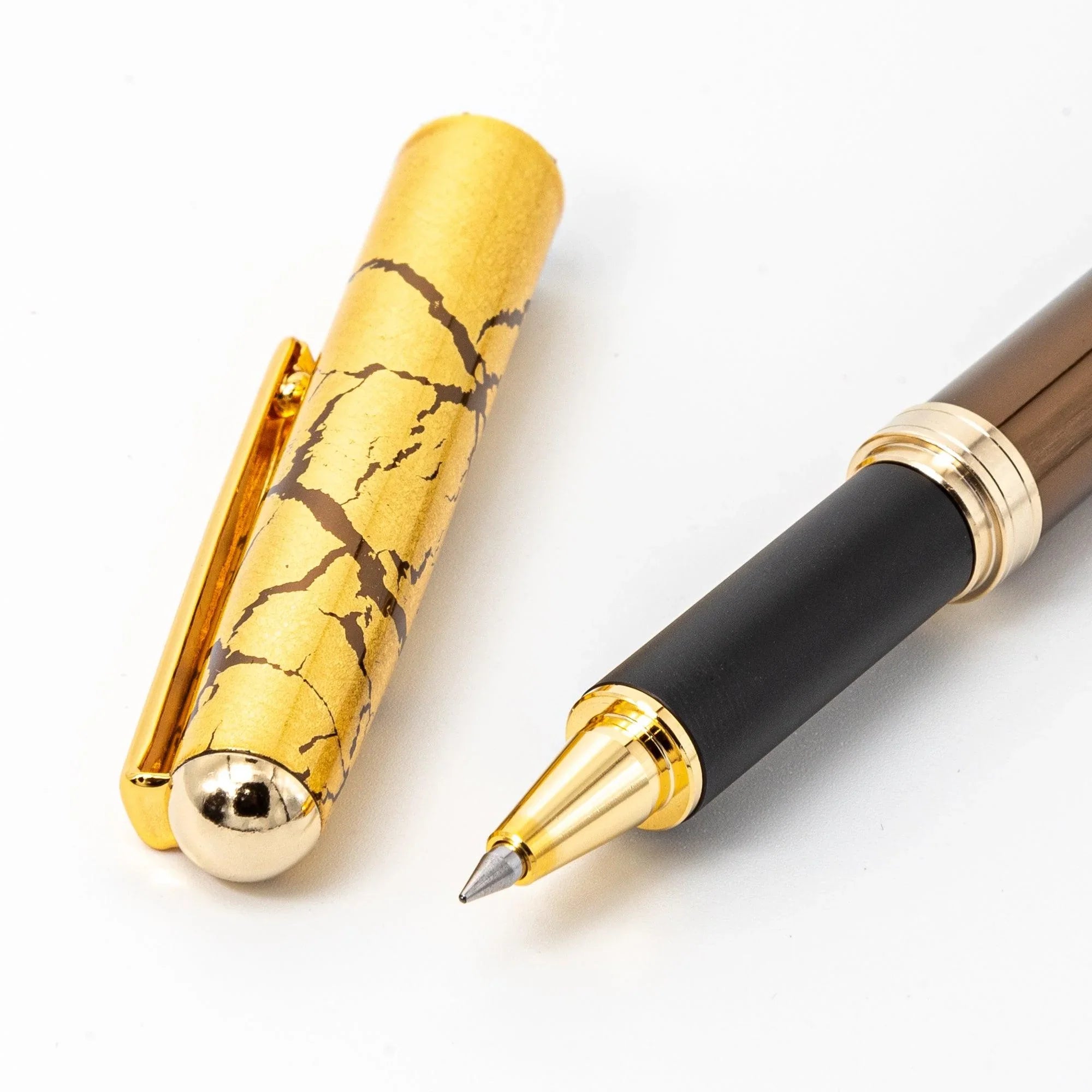 Japanese brown ballpoint pen uncapped barrel with gold clip and bands, gold crackle cap displayed separately