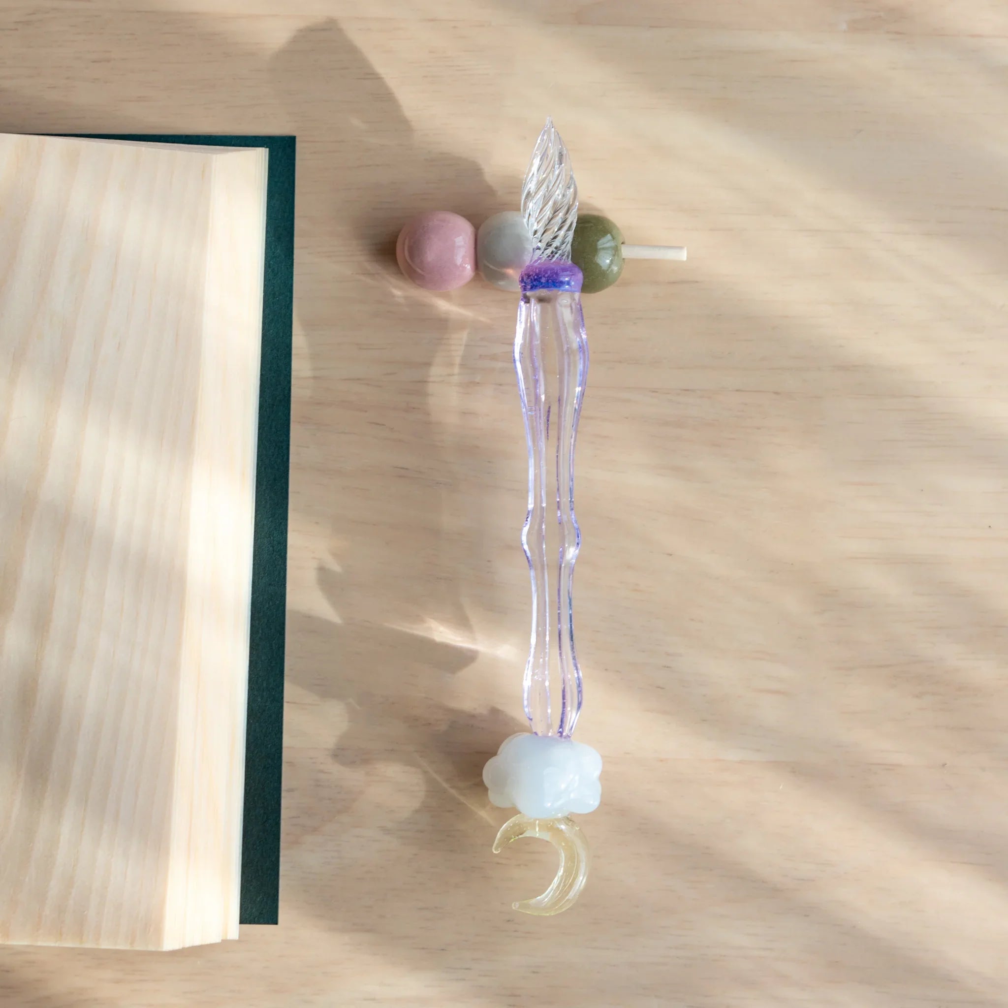 Three-bead dango handcrafted pen rest in pink, gray and olive green with purple decorative ribbon charm accent