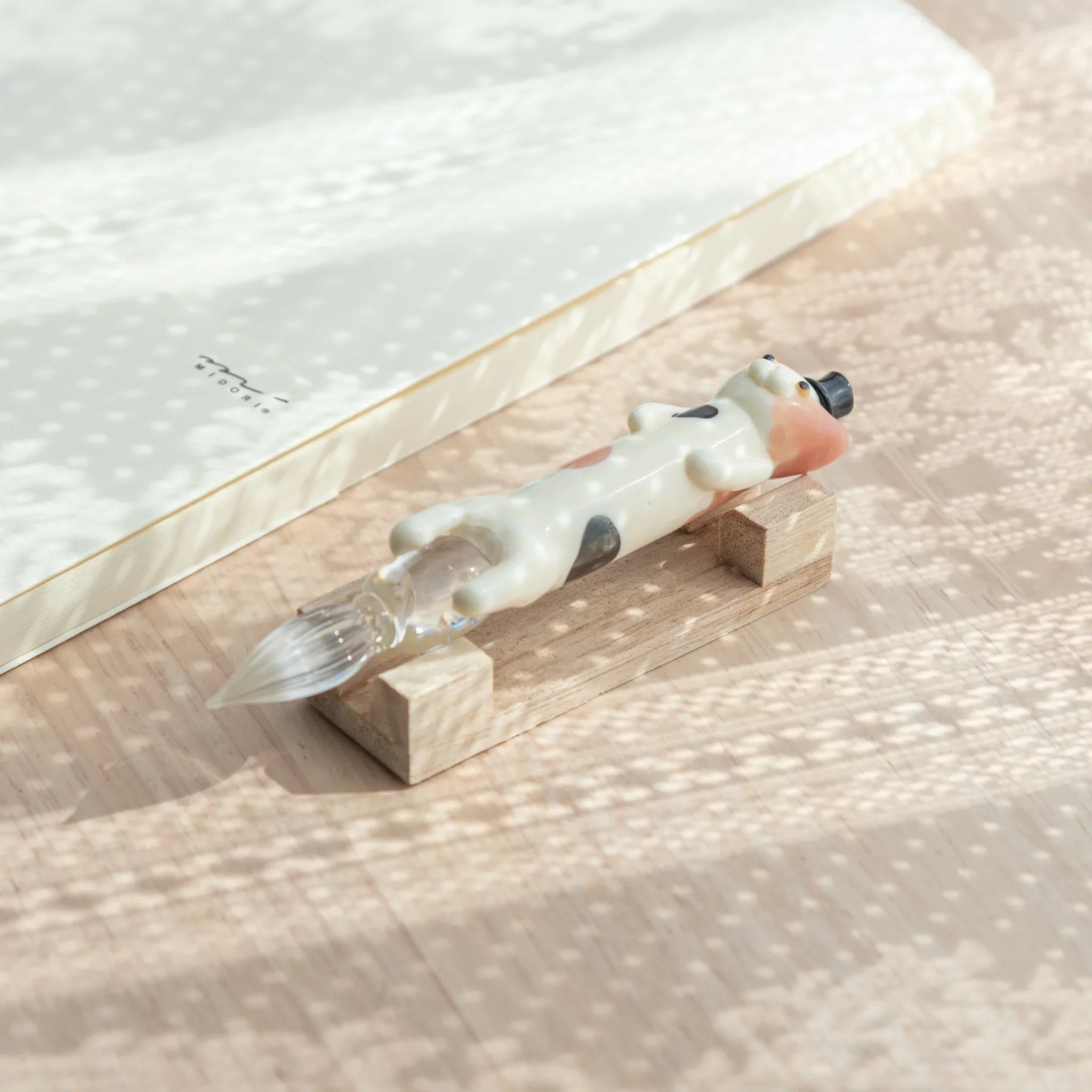 Hand-painted spotted cat glass dip pen with vibrant resin creature holding colored glass ink vial design