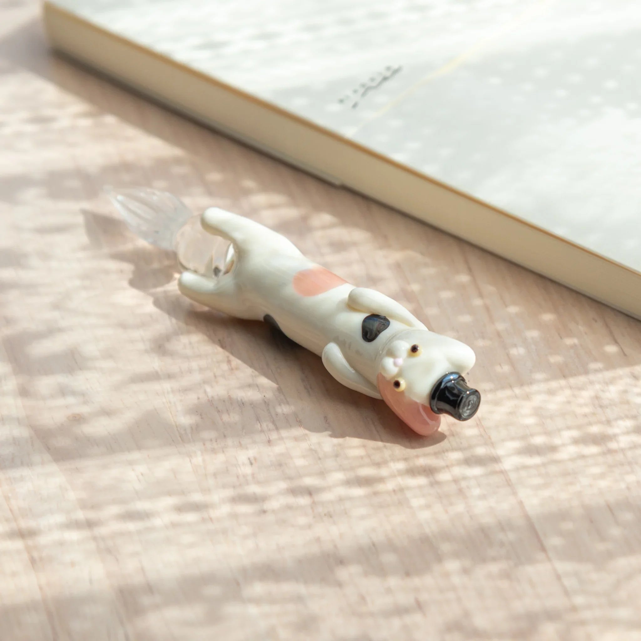 hand-made cat glass dip pen with dapper spotted feline holding decorative colored glass ink bottle design