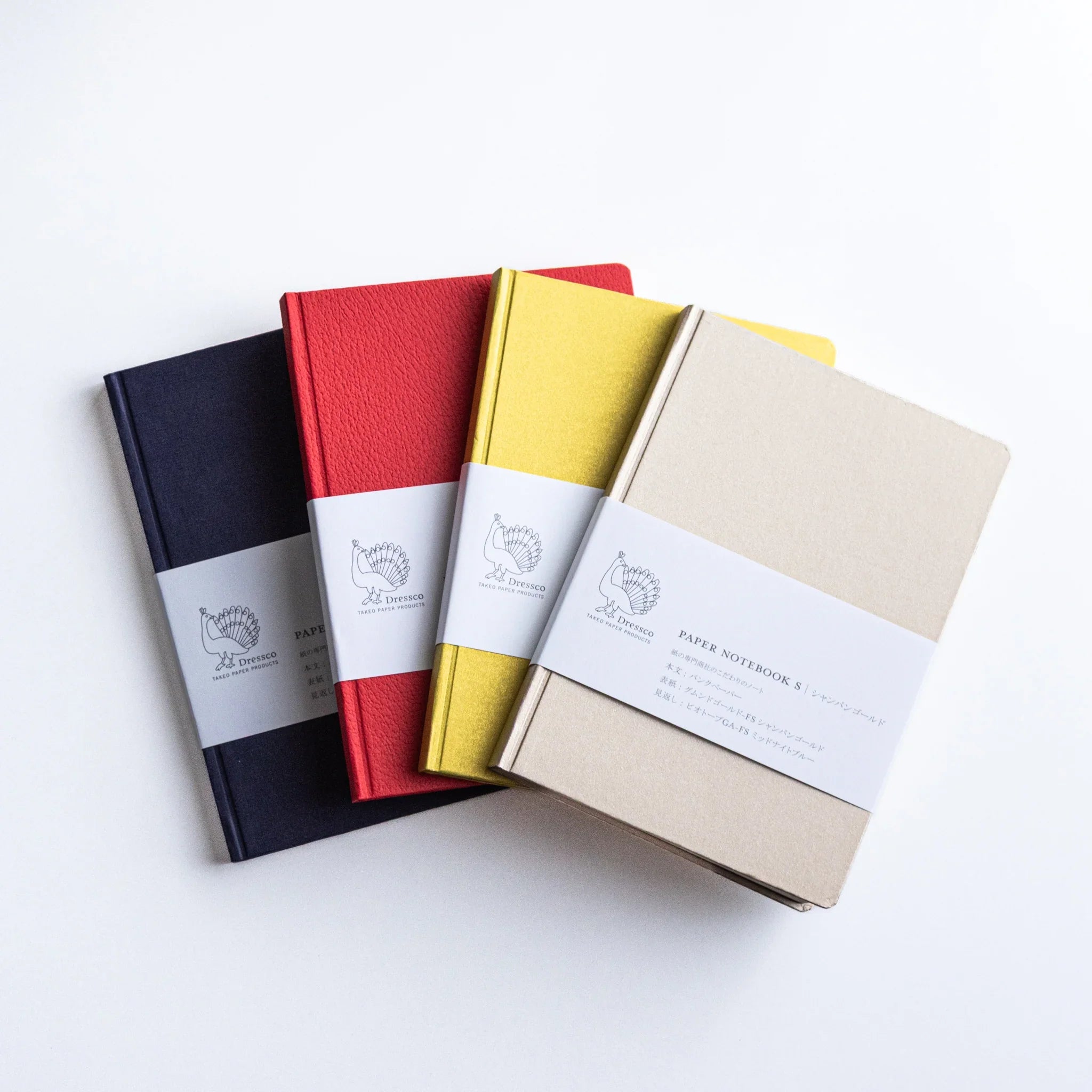 Dressco Bank Ledger Paper Japanese Notebooks in Navy, Red, Gold, and Champagne Gold, arranged in a row.