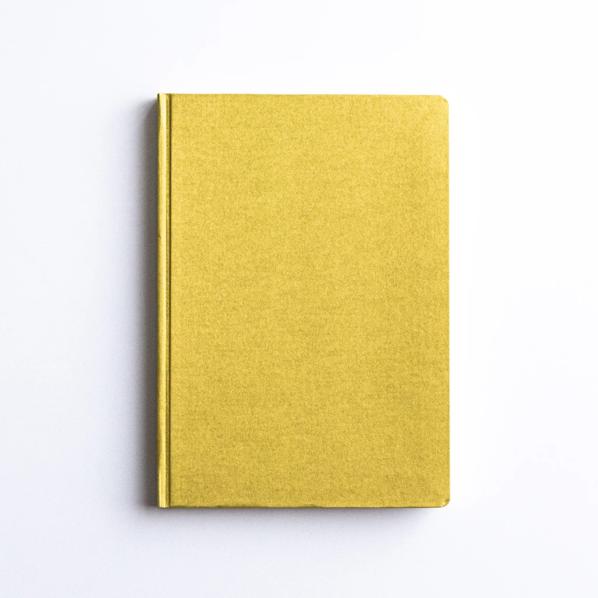 Minimalist top view of Dressco Bank Ledger Paper Japanese Notebook in Gold.