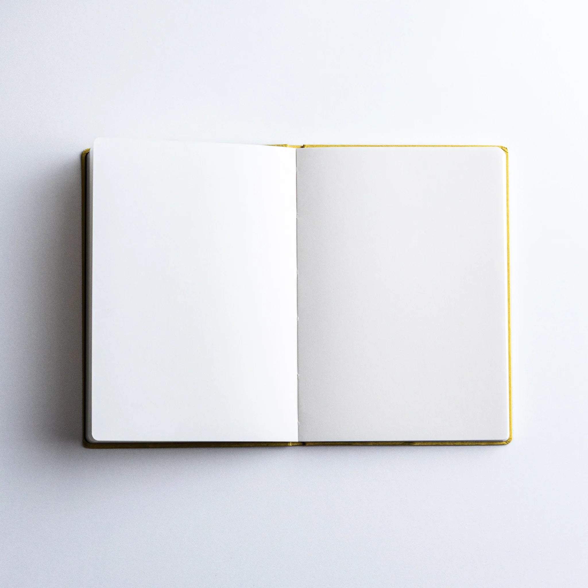 Dressco Bank Ledger Paper A6 notebook from the side showing the spine width and number of pages visible from edge