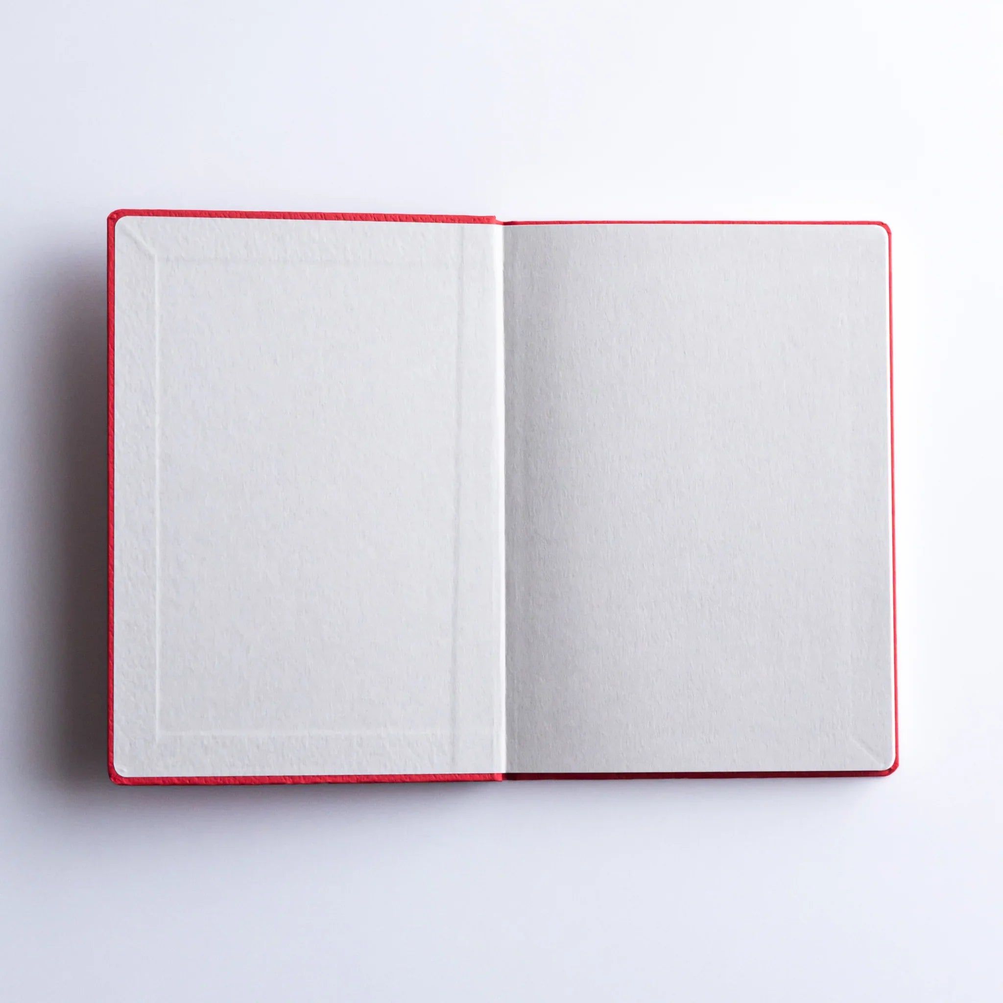 Dressco Bank Ledger Paper A6 notebook angled view showing cover color and the stitched spine detail at the edge