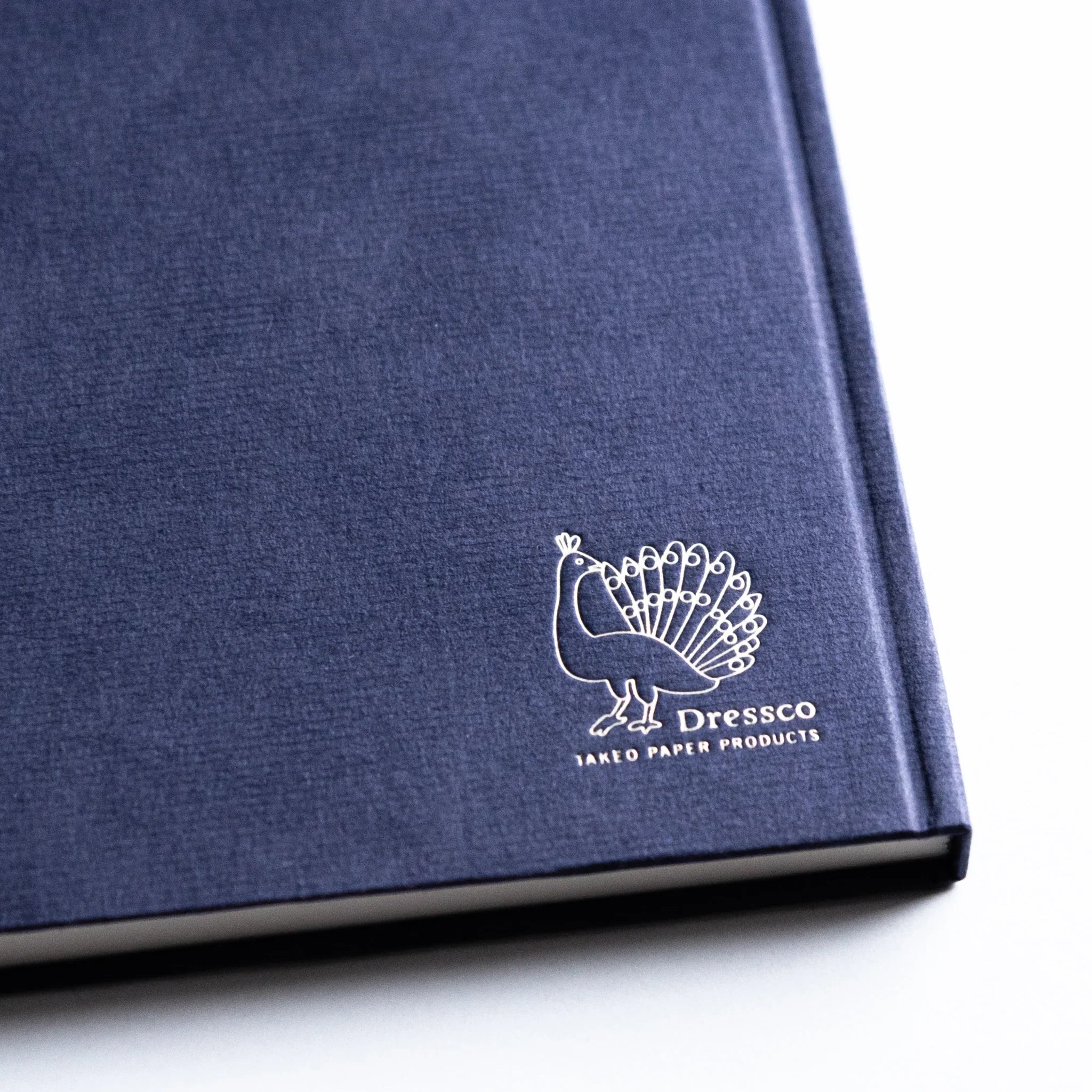 Close-up of logo on Dressco Bank Ledger Paper Japanese Notebook in Navy.