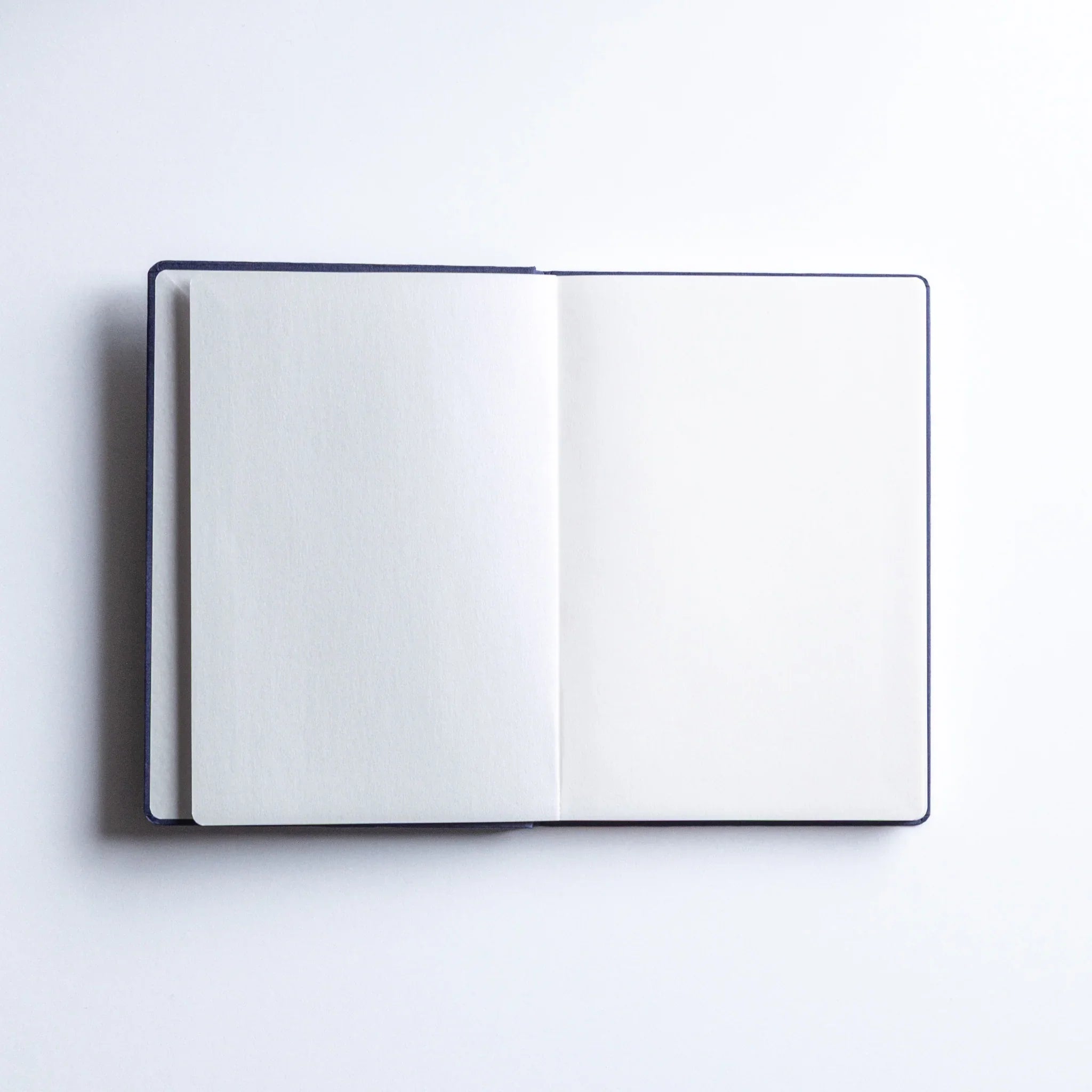 Open Dressco Bank Ledger Paper Japanese Notebook in Navy Blue showing clean blank pages.