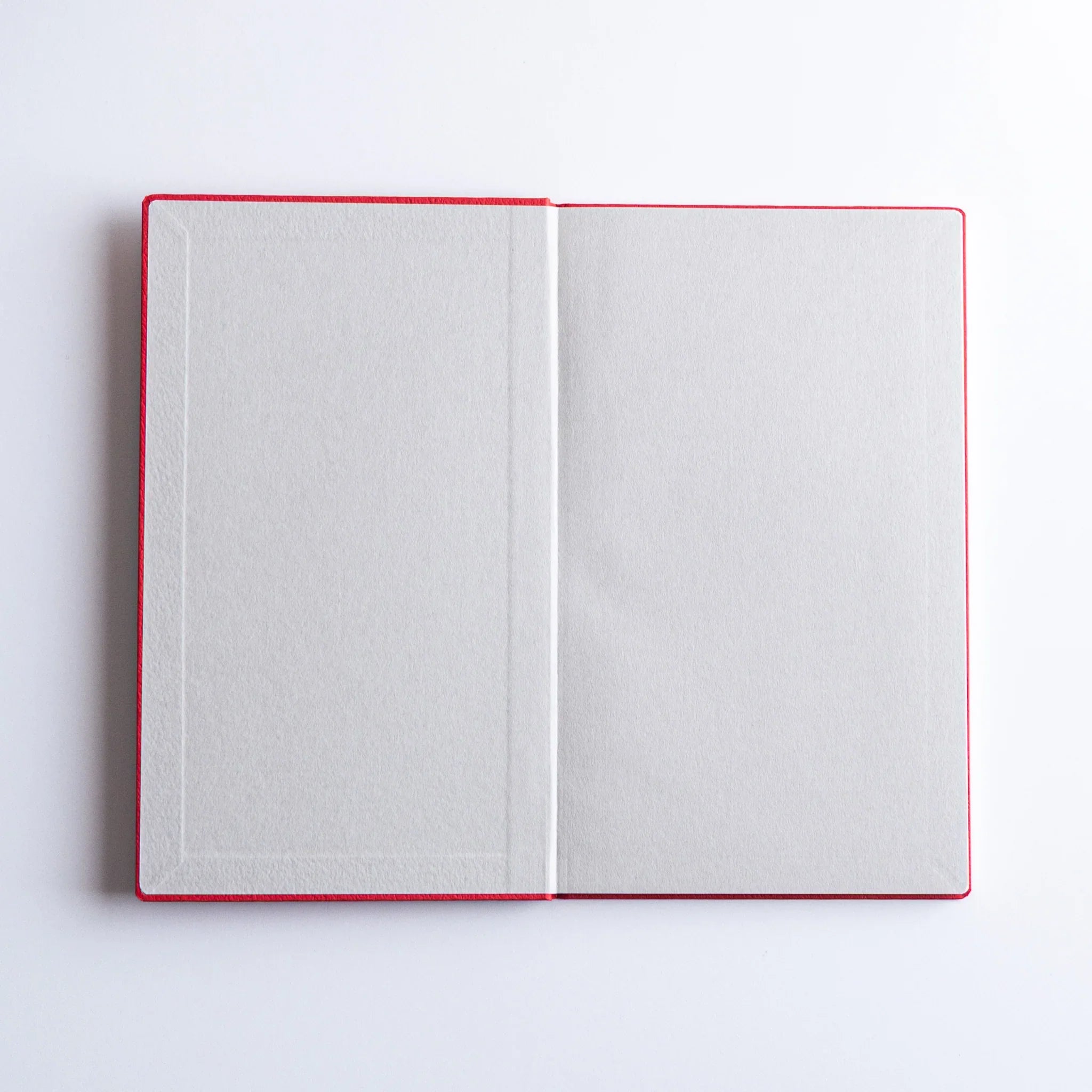 Dressco bank ledger paper A6 notebook, angled three-quarter view showing texture and cover design, Japanese Dressco
