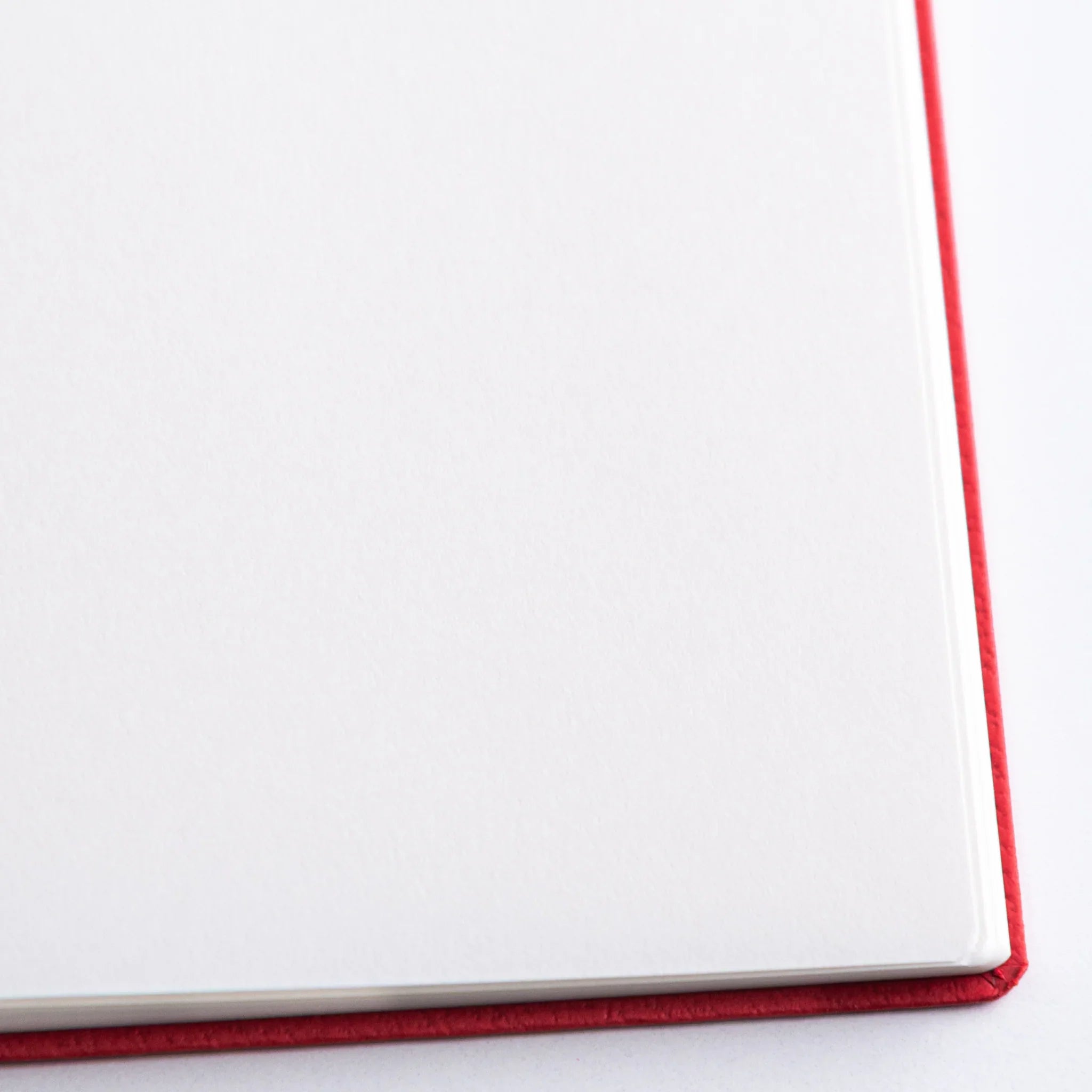 Close-up of Dressco Bank Ledger Paper Japanese Notebook – Red, showing fine smooth paper texture.