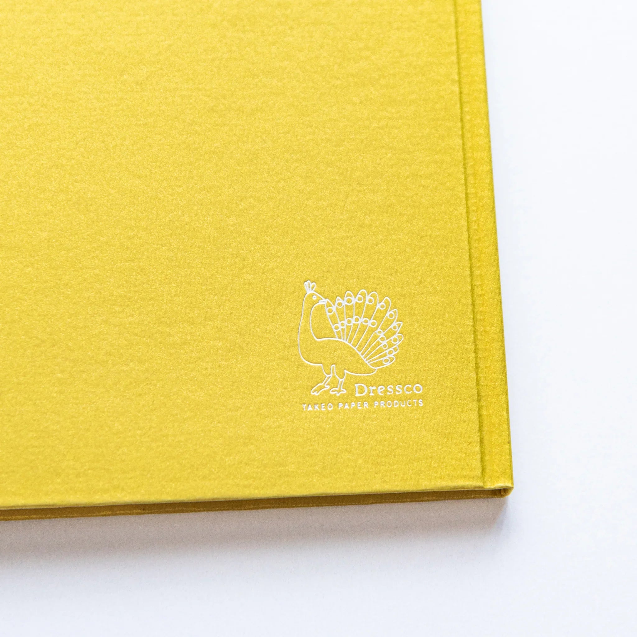 Dressco bank ledger paper A6 notebook, angled three-quarter view showing texture and cover design, Japanese Dressco passbook