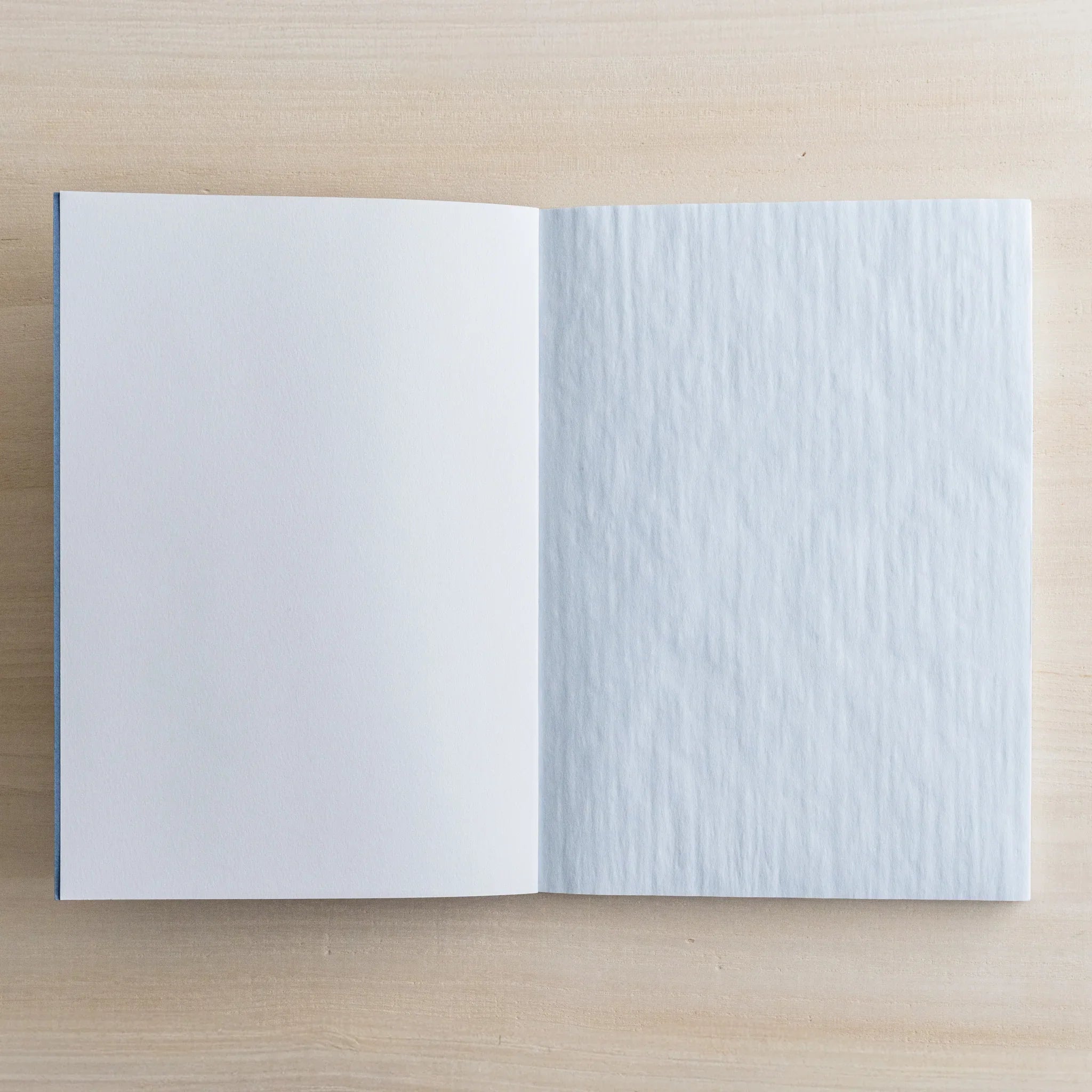 Close-up of indigo blue Dressco cover showing rich color depth and onion skin paper texture for writing and personal corre