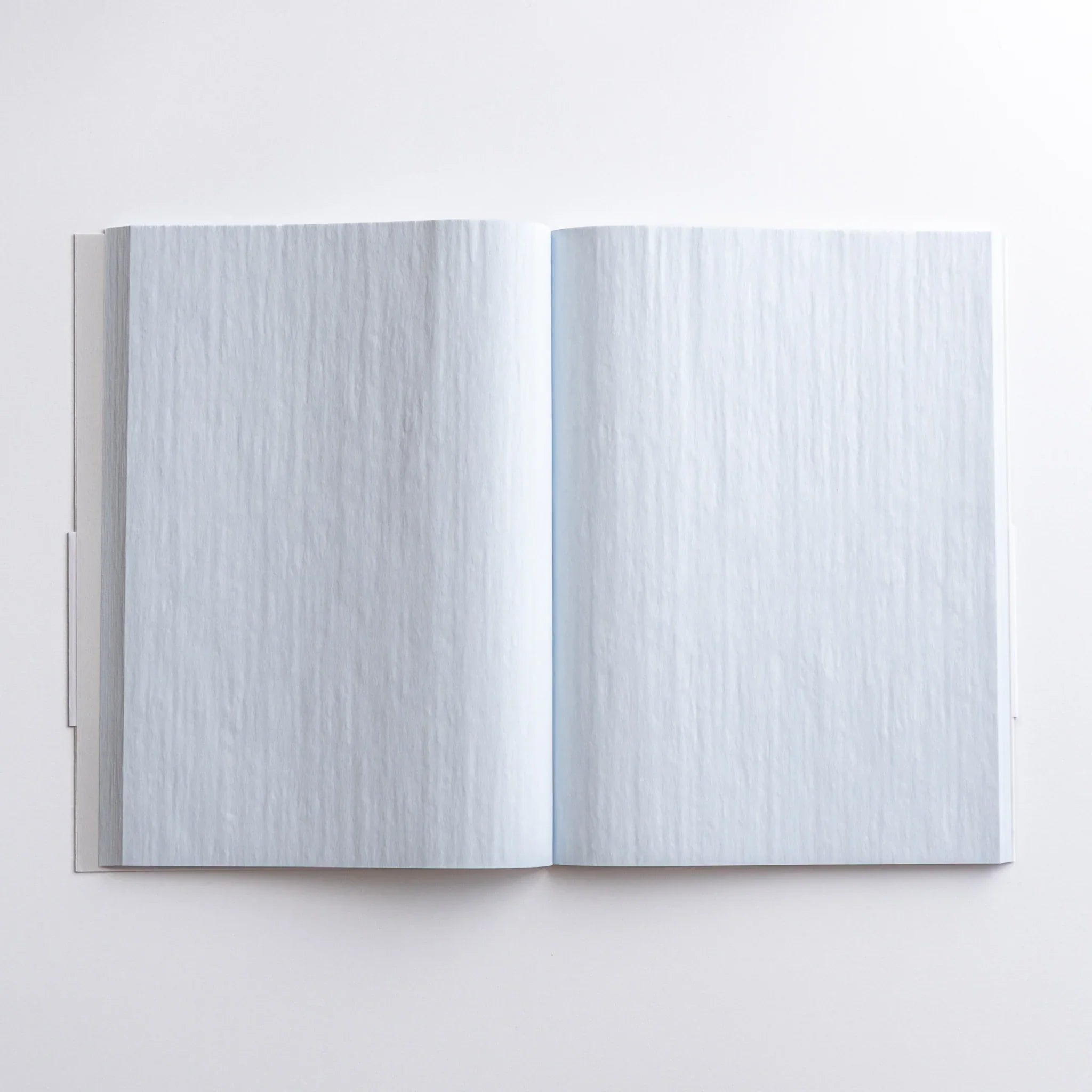 Dressco Blue B6 notebook closed flat lay on wooden surface showing proportions and size for writing and personal correspon