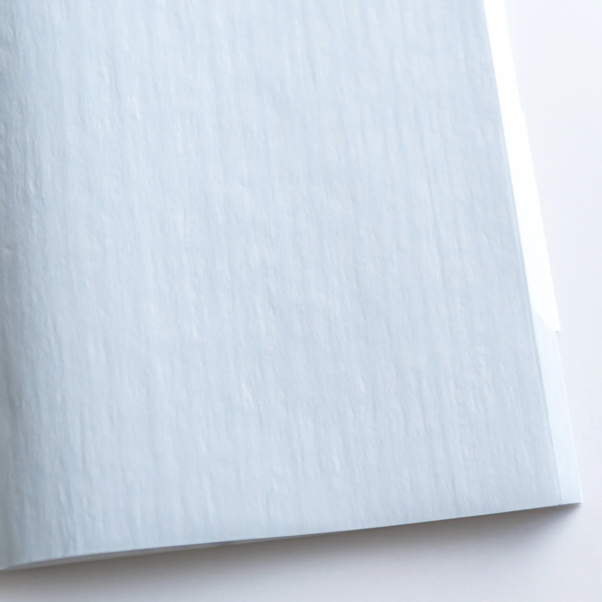 Dressco Blue notebook pages fanned showing thin paper and translucent quality of onion skin for writing and personal corre