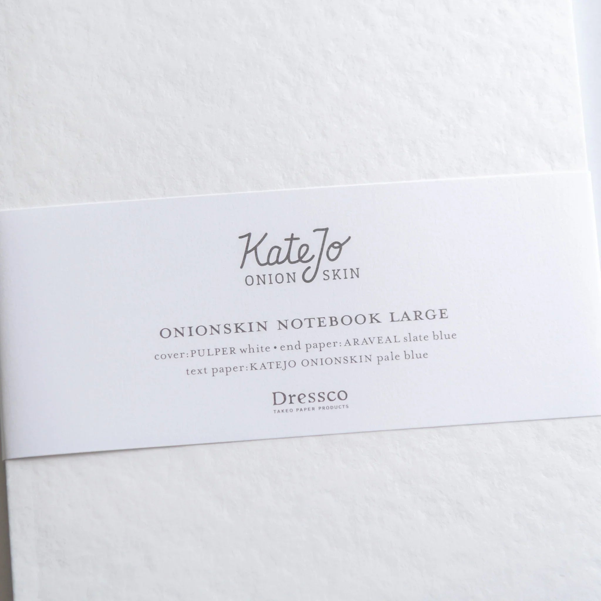 Close-up of Dressco Blue Onion Skin Japanese Notebook B6 band, showing product title and elegant texture.