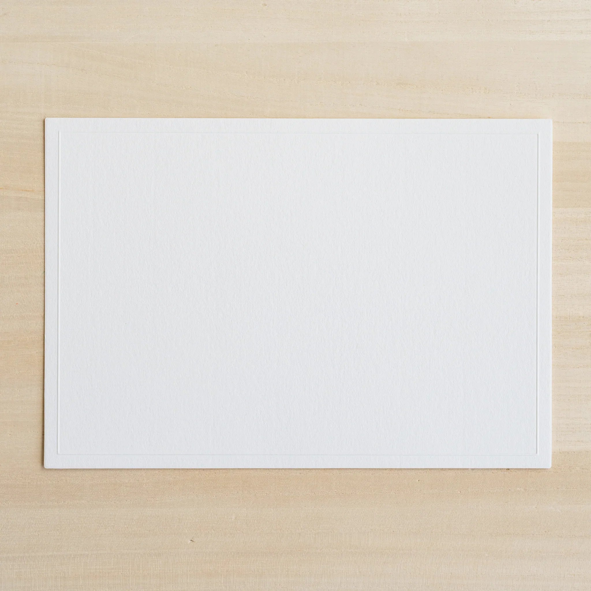 Overhead view of Dressco Conqueror message card set on white background for personal correspondence and gifting
