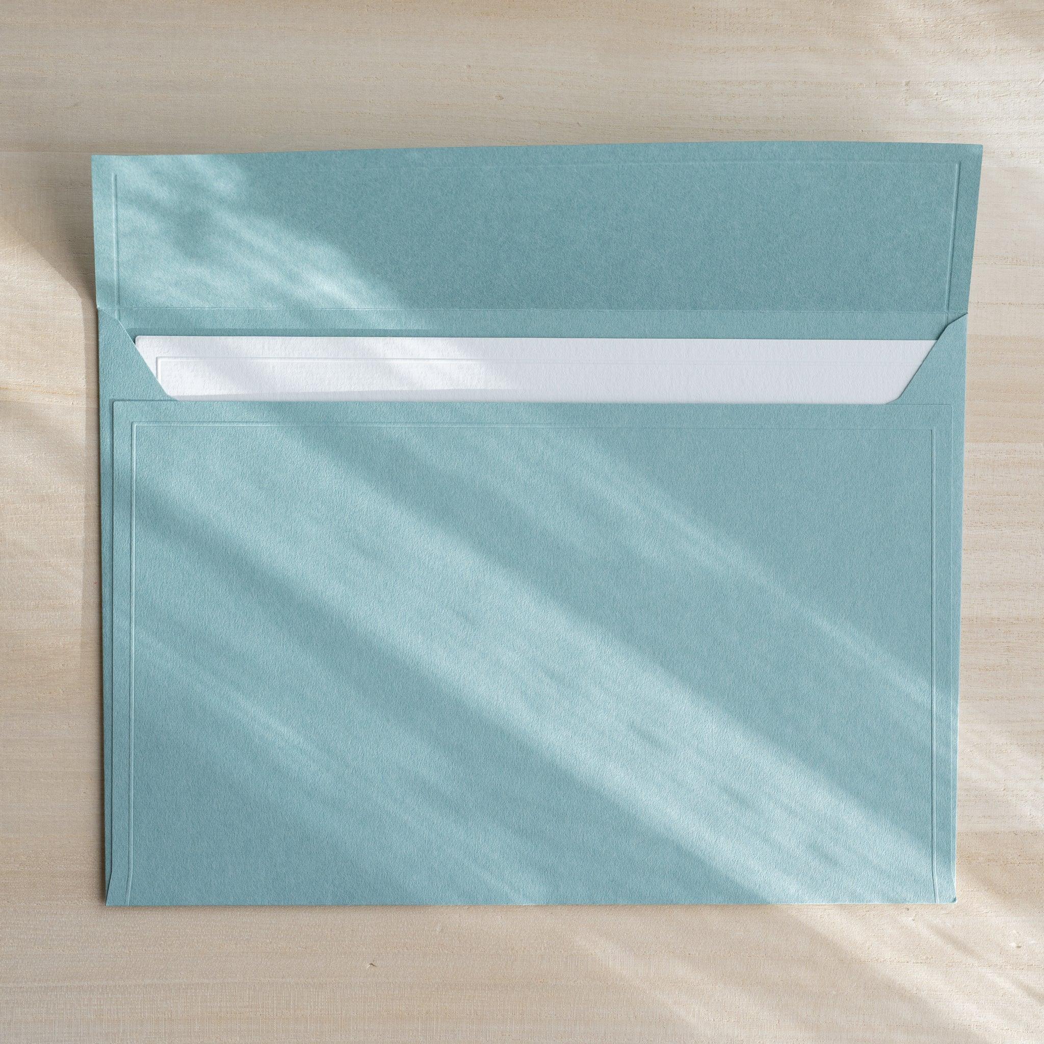 Dressco ivory large embossed envelope image eleven, front view showing sealed flap, with raised embossing, set of three