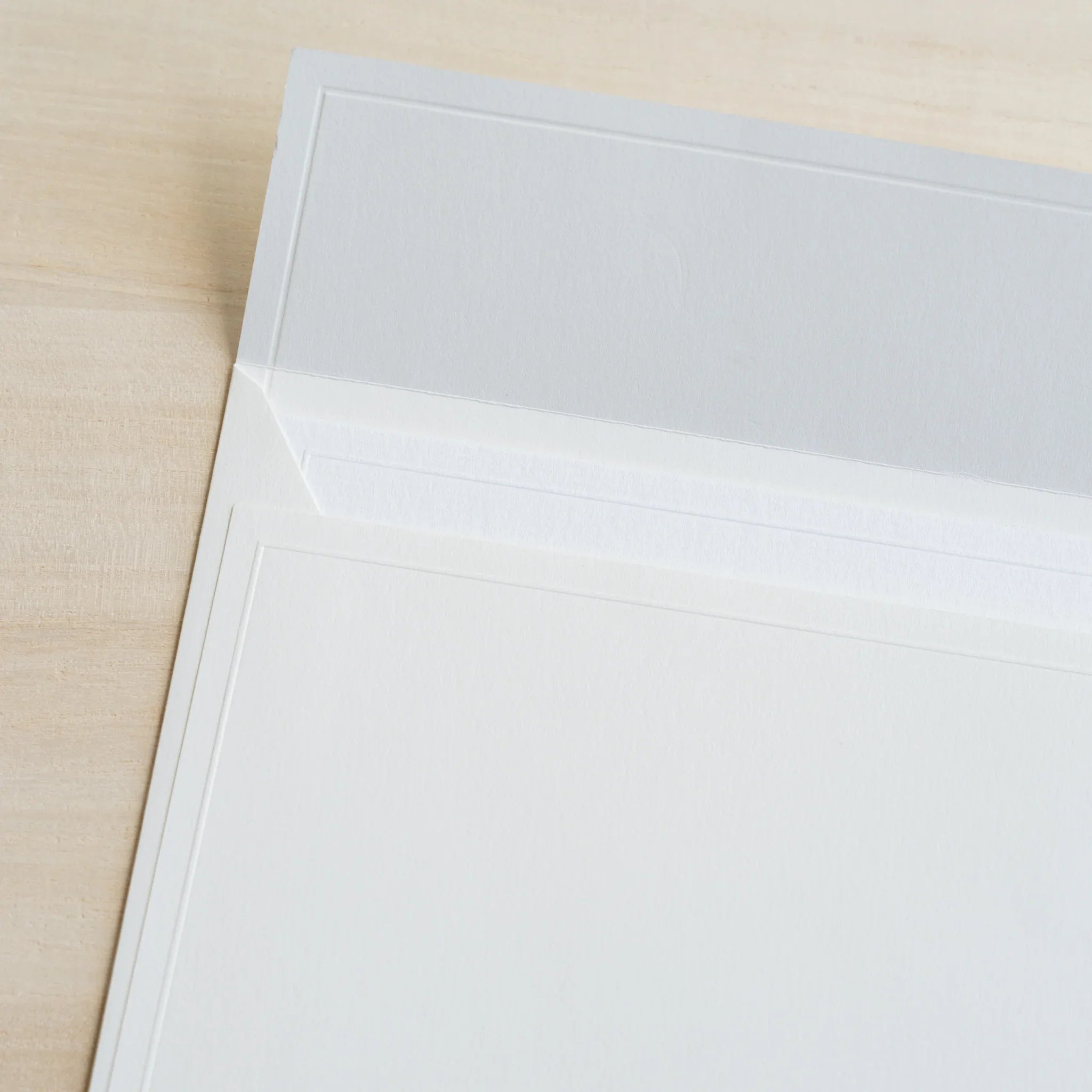 Dressco ivory large embossed envelope image twenty-five, overhead flat composition, with embossed surface, set of three