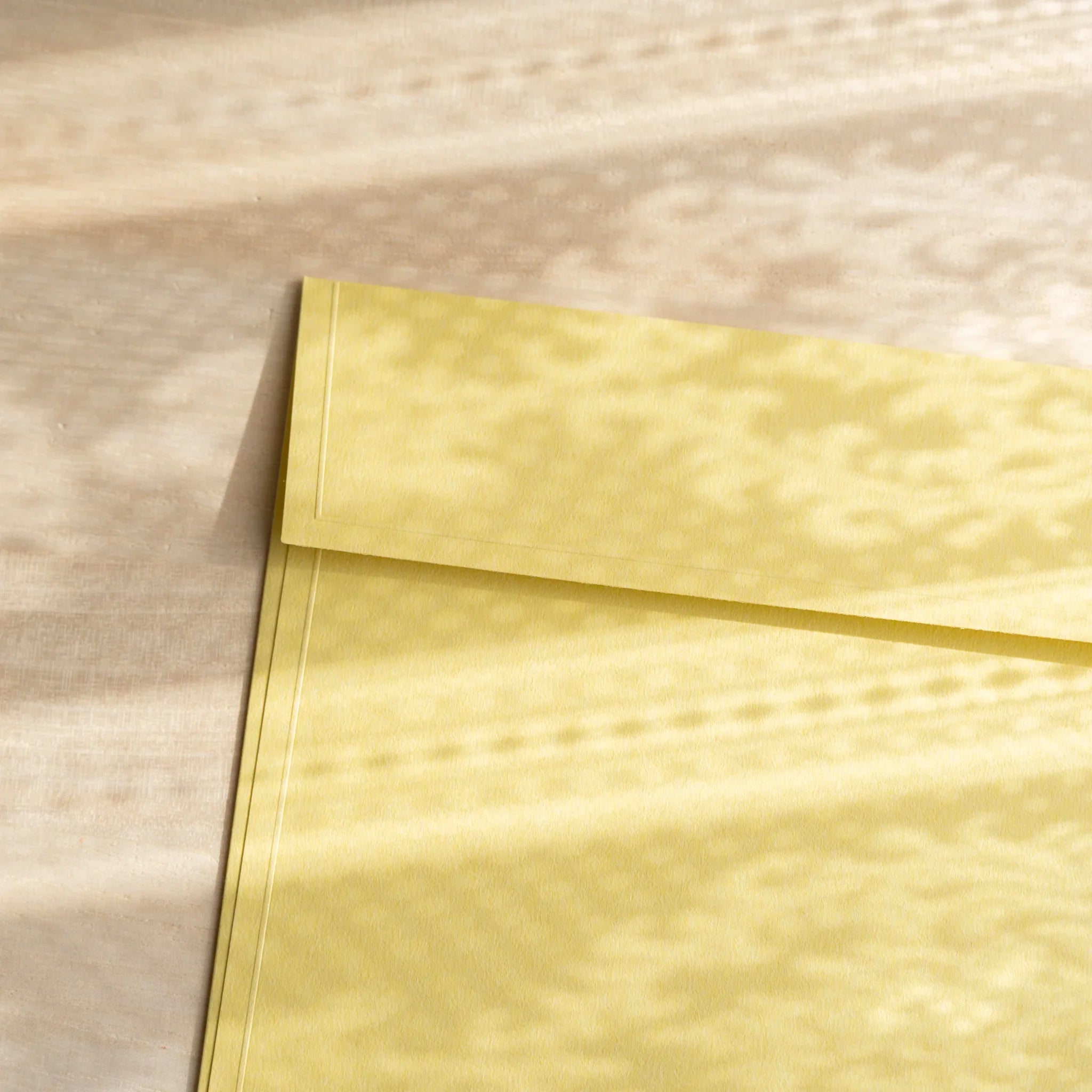 Dressco ivory large embossed envelope image thirty-five, overhead flat composition, with embossed surface, set of three