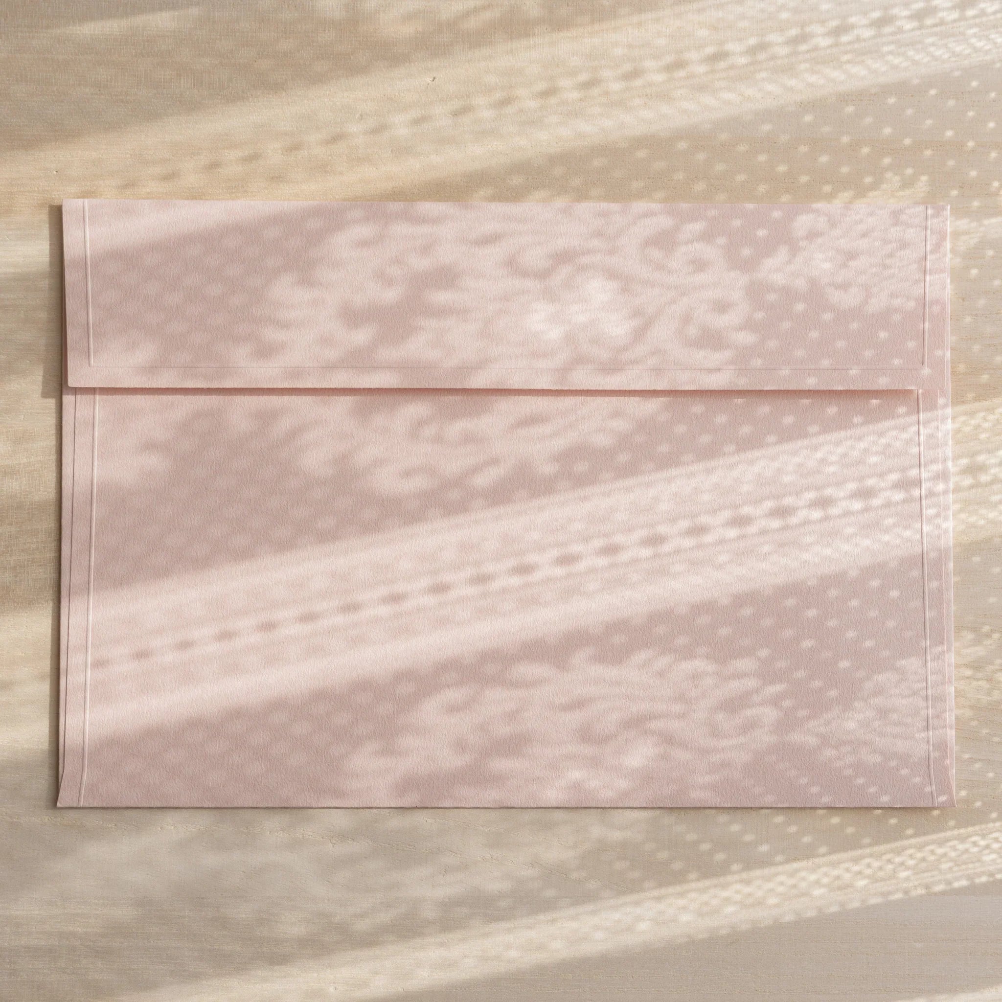 Dressco ivory large embossed envelope image forty-five, overhead flat composition, with embossed surface, set of three