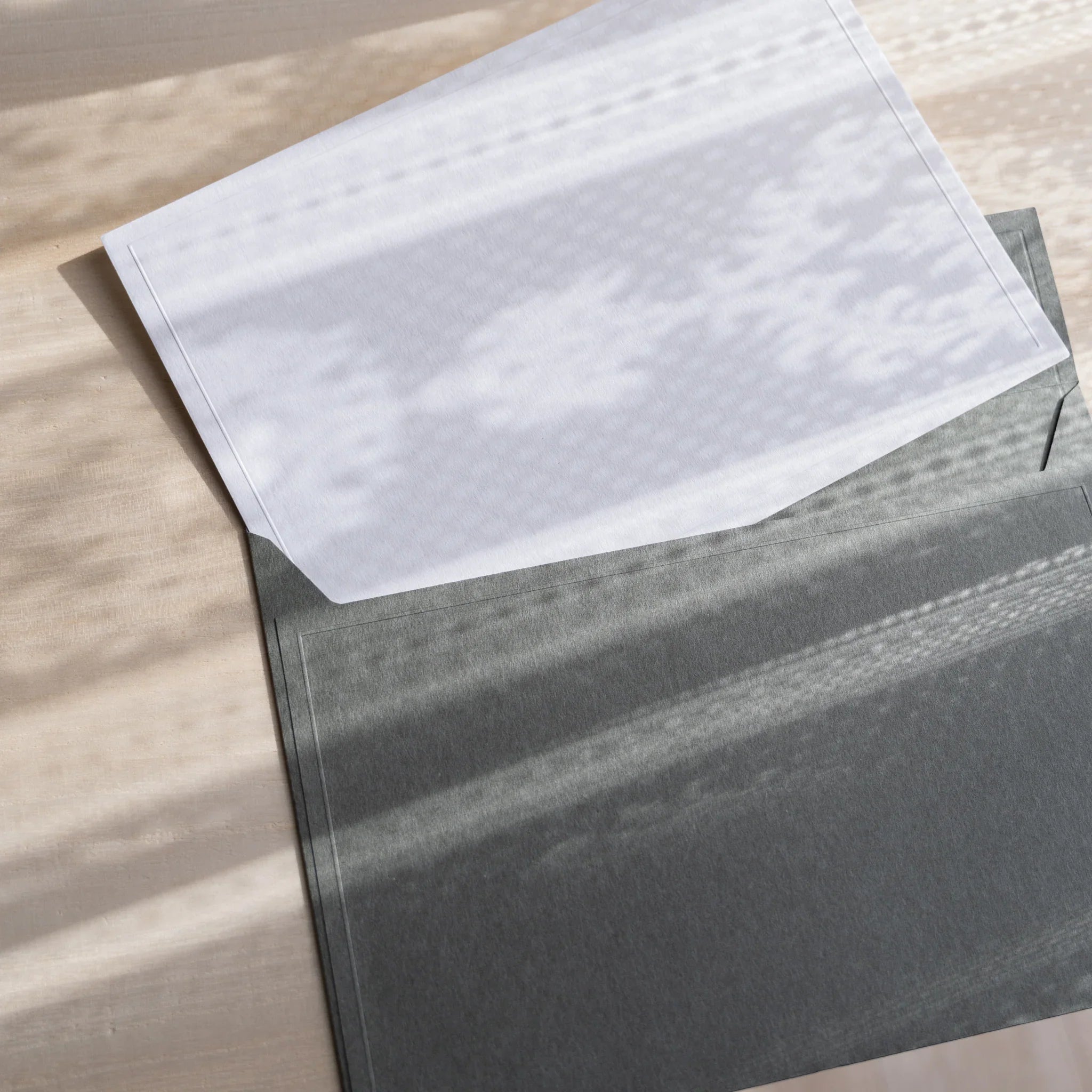 Dressco ivory large embossed envelope image sixty-one, front view showing sealed flap, with raised embossing, set of three