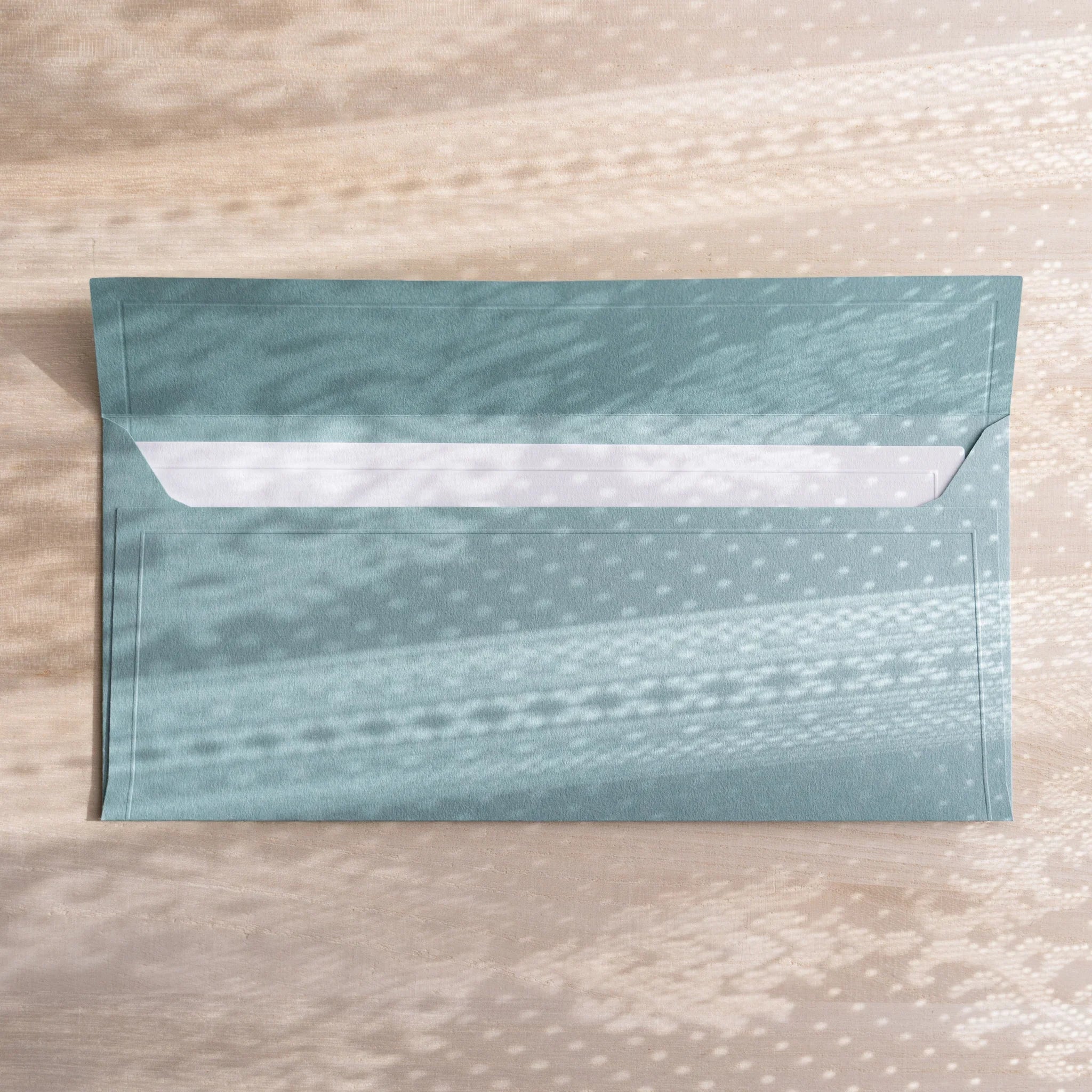 Dressco ivory medium embossed envelope image ten, stacked arrangement view, with embossing elegance, set of three