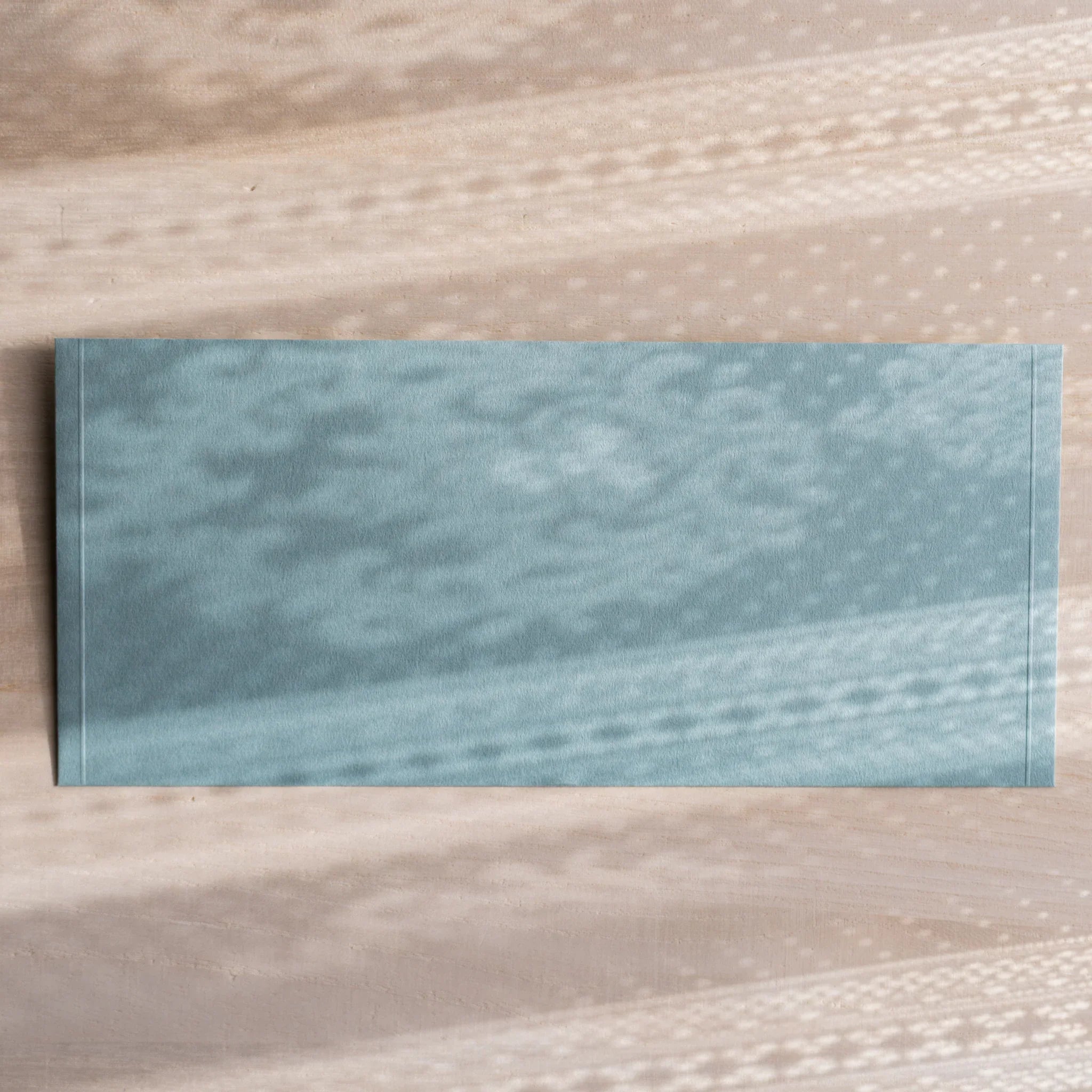 Dressco ivory medium embossed envelope image eleven, front view showing sealed flap, with raised embossing, set of three