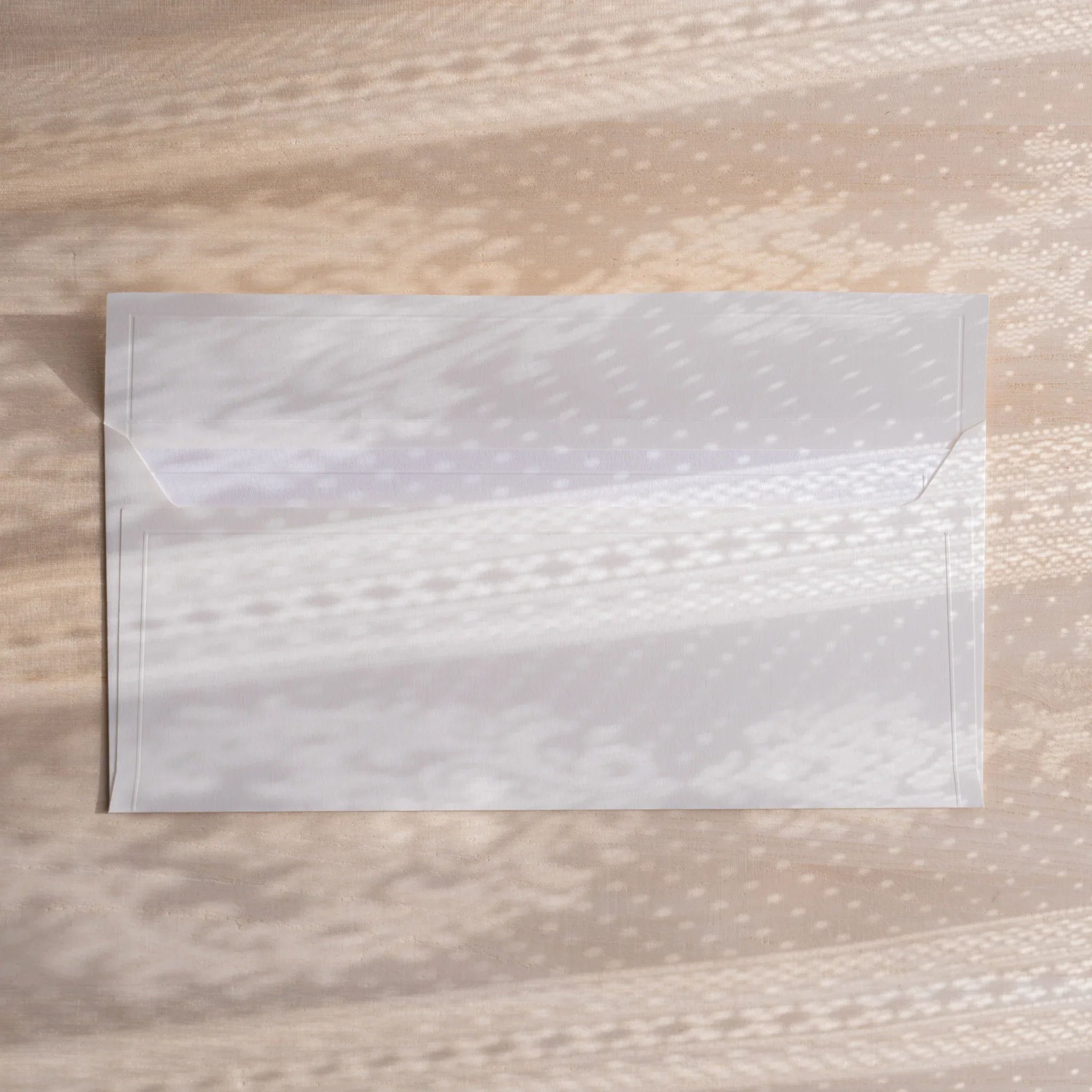 Dressco ivory medium embossed envelope image twenty-one, front view showing sealed flap, with raised embossing, set of three