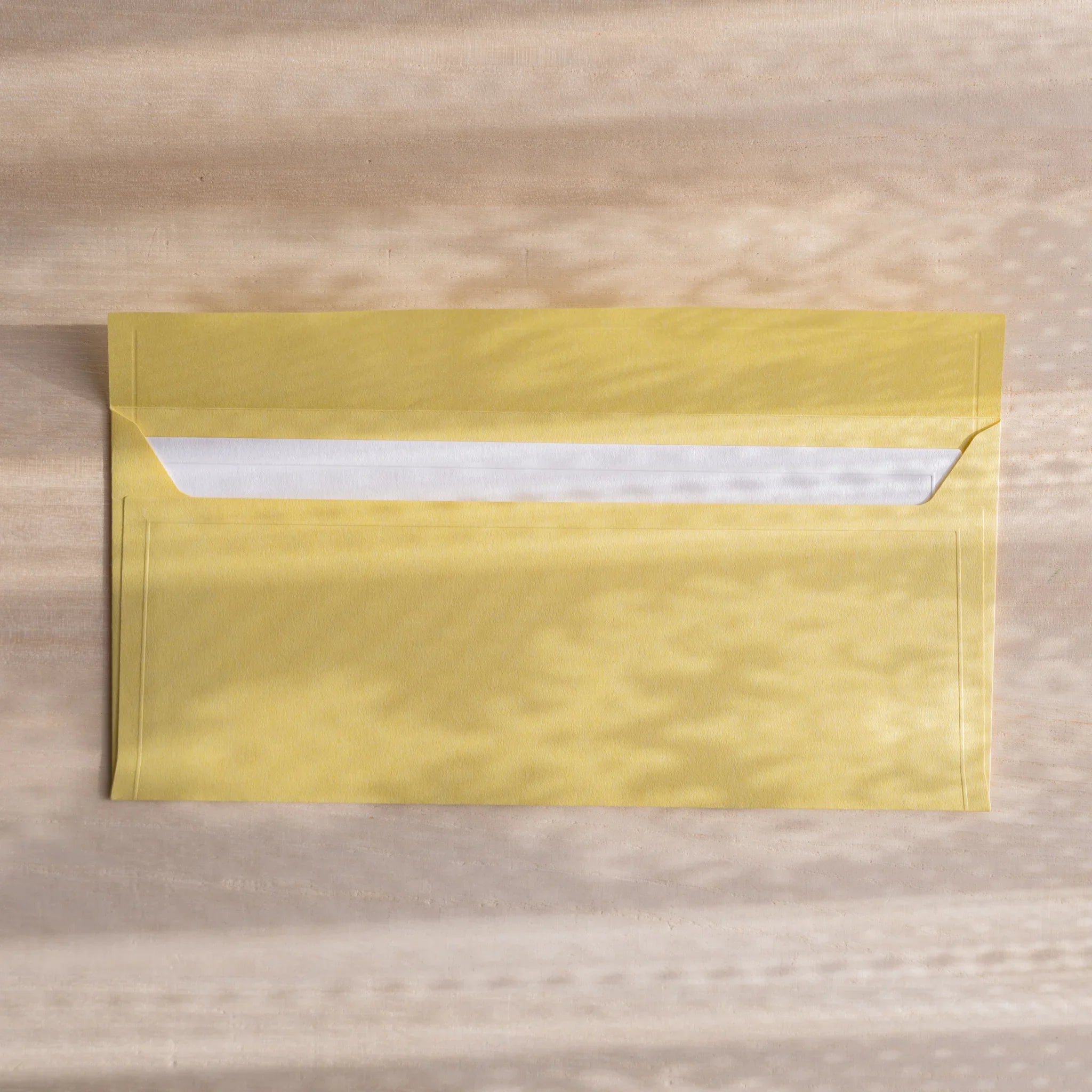 Dressco ivory medium embossed envelope image thirty-one, front view showing sealed flap, with raised embossing, set of three