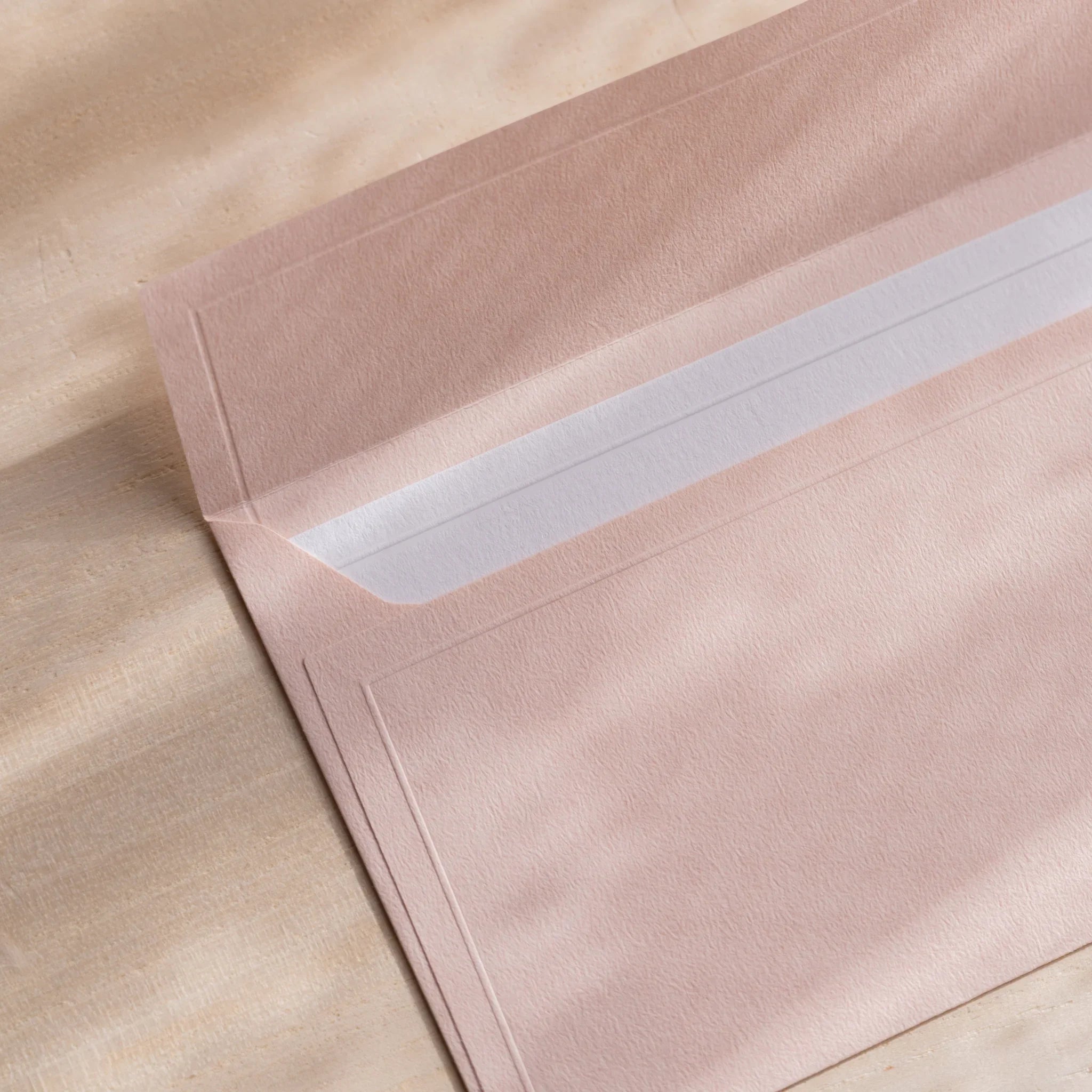 Dressco ivory medium embossed envelope image forty-one, front view showing sealed flap, with raised embossing, set of three