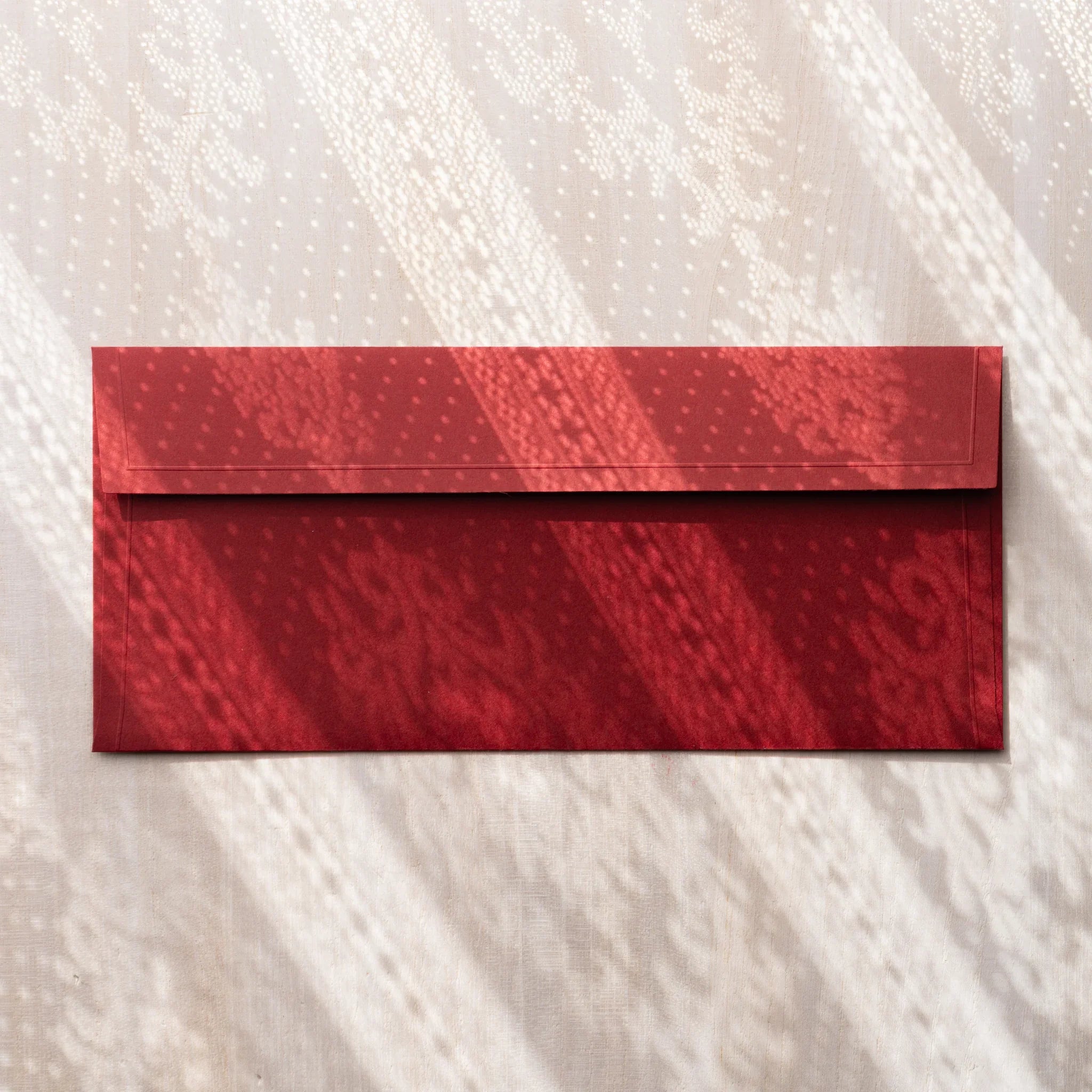 Dressco ivory medium embossed envelope image sixty-five, overhead flat composition, with embossed surface, set of three