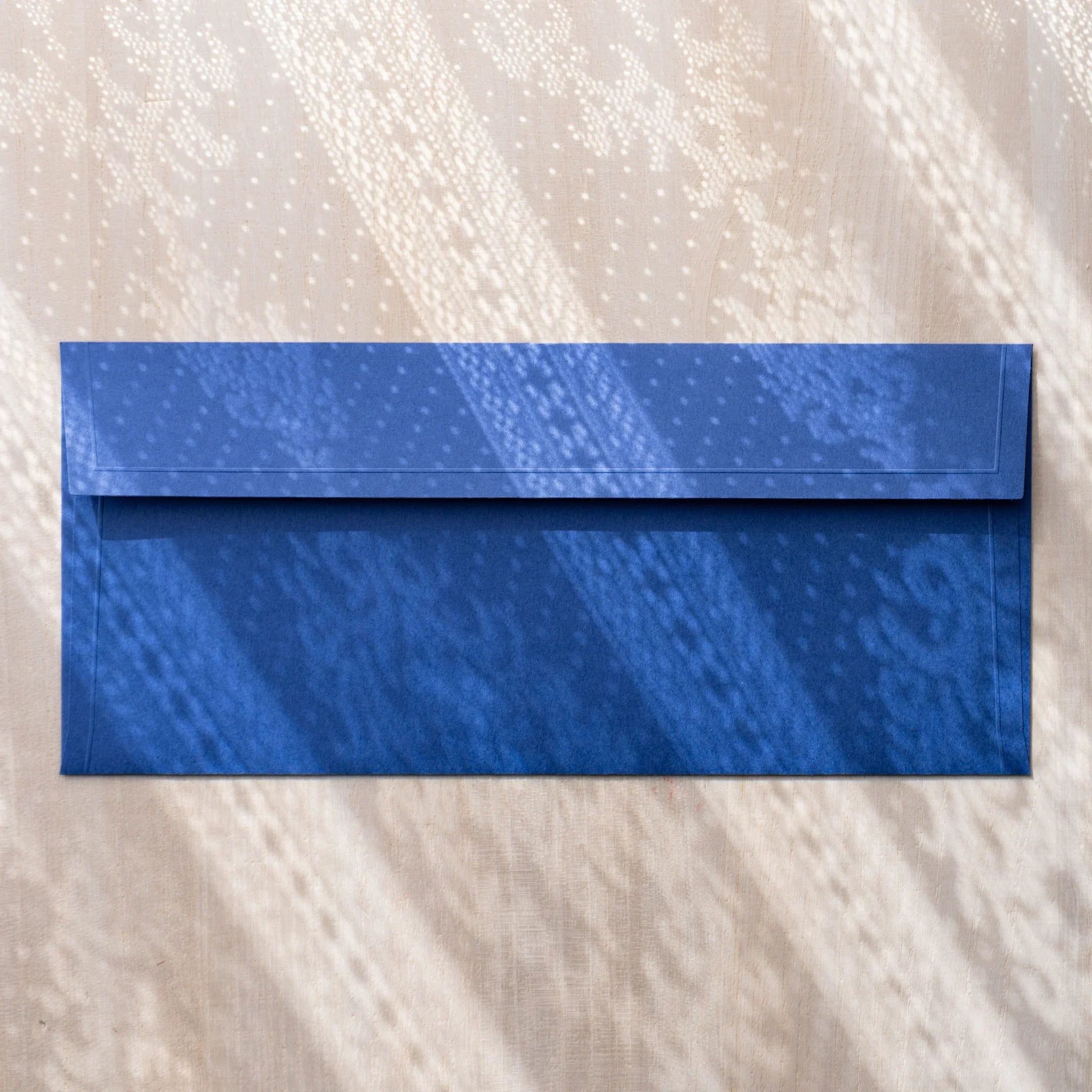 Dressco ivory medium embossed envelope image seventy-five, overhead flat composition, with embossed surface, set of three