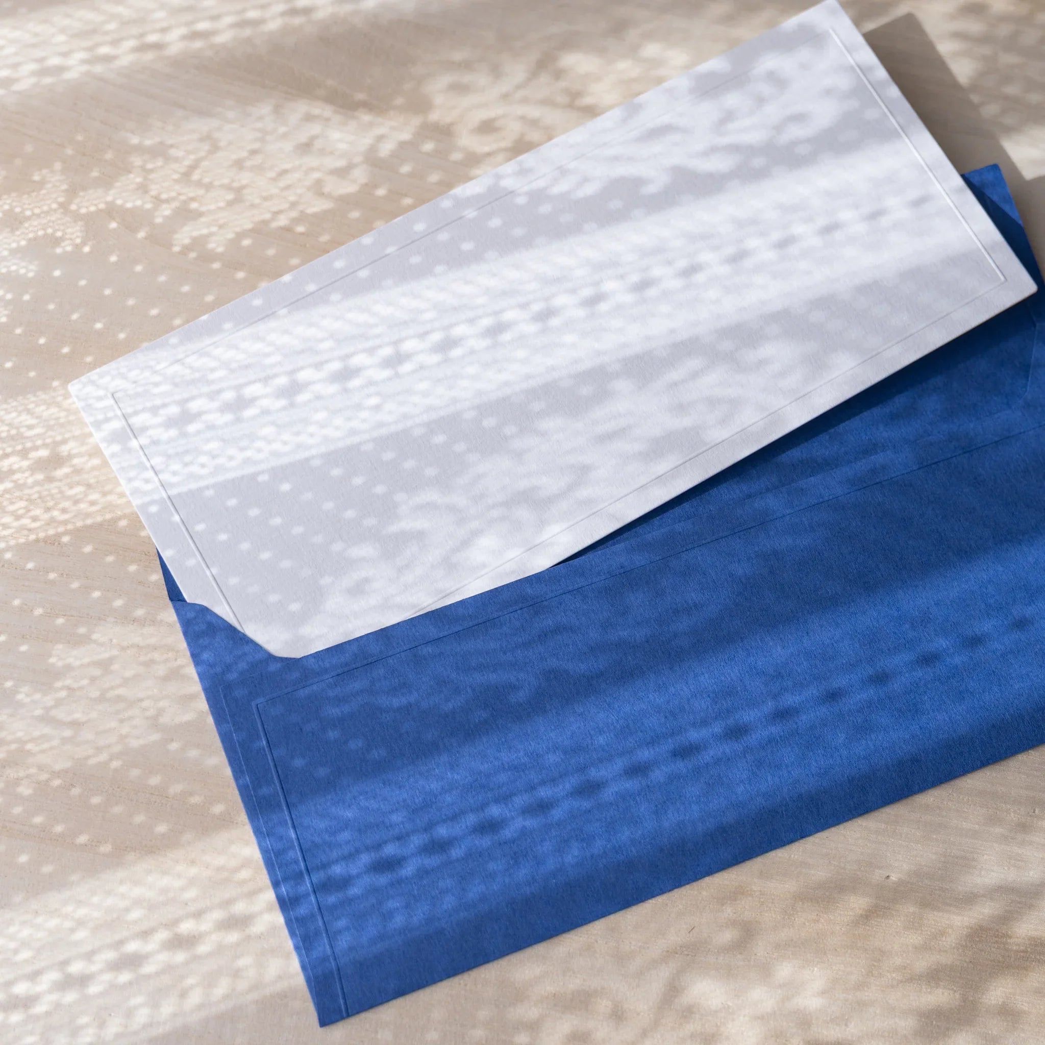 Dressco ivory medium embossed envelope image seventy-nine, fanned display layout, with embossed paper, set of three