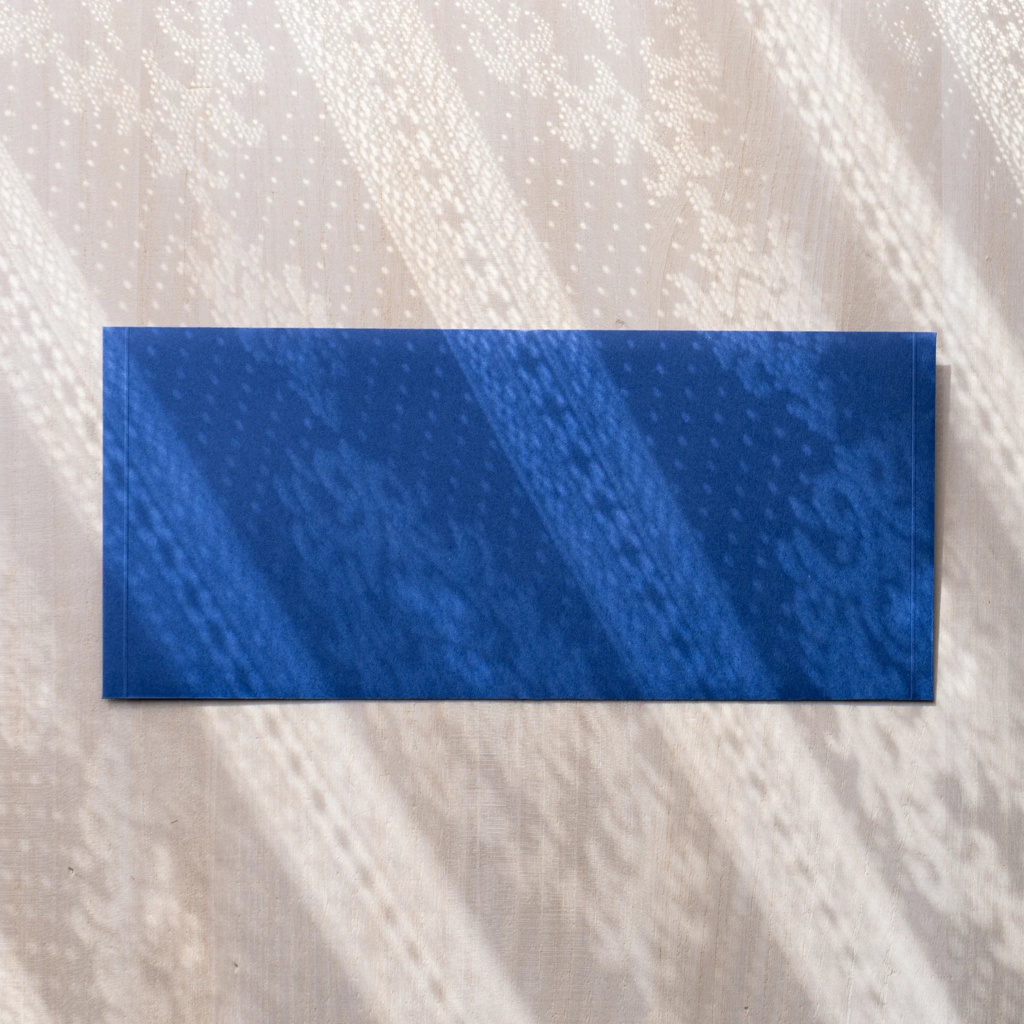 Dressco ivory medium embossed envelope image eighty-one, front view showing sealed flap, with raised embossing, set of three