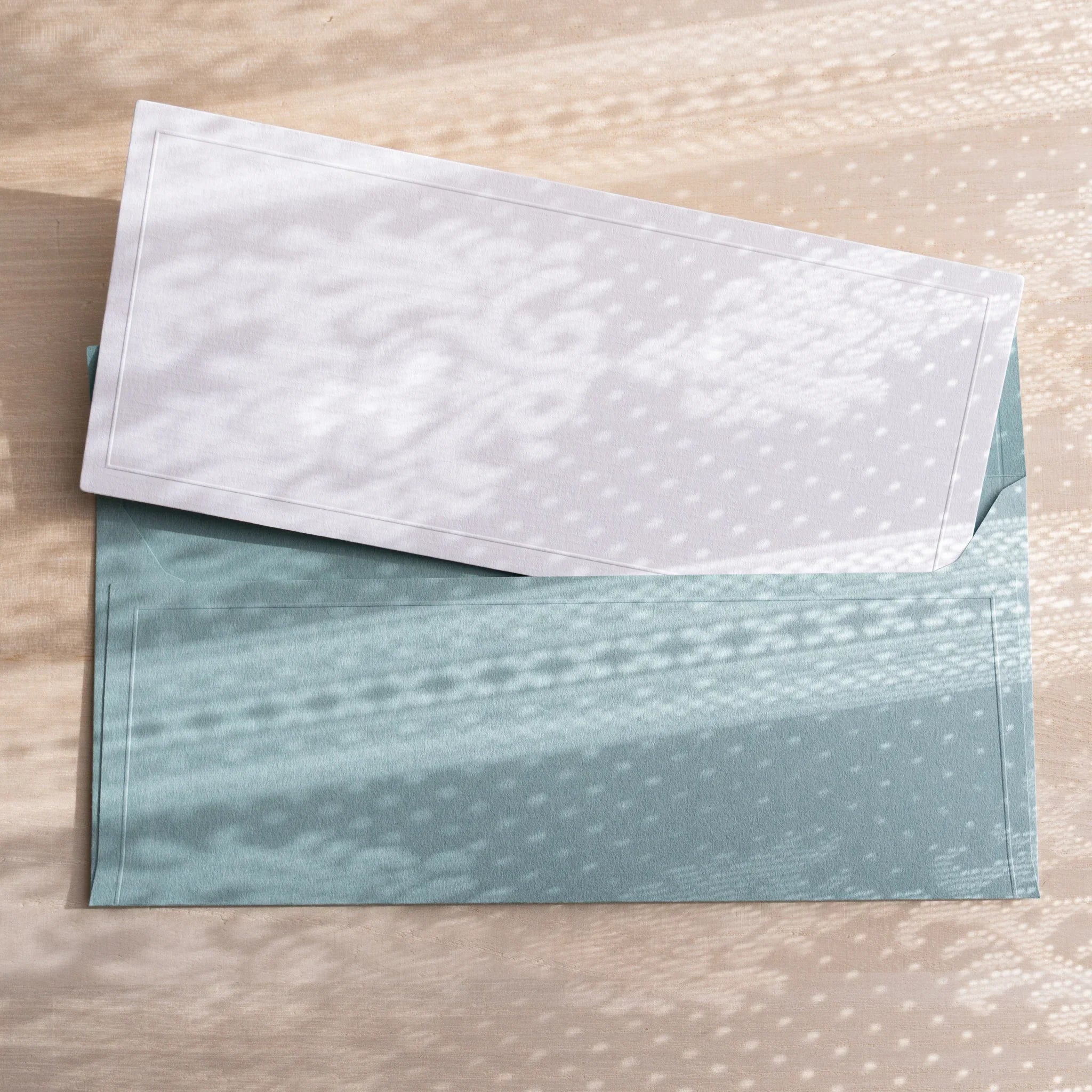 Dressco ivory medium embossed envelope image nine, fanned display layout, with embossed paper, set of three quality