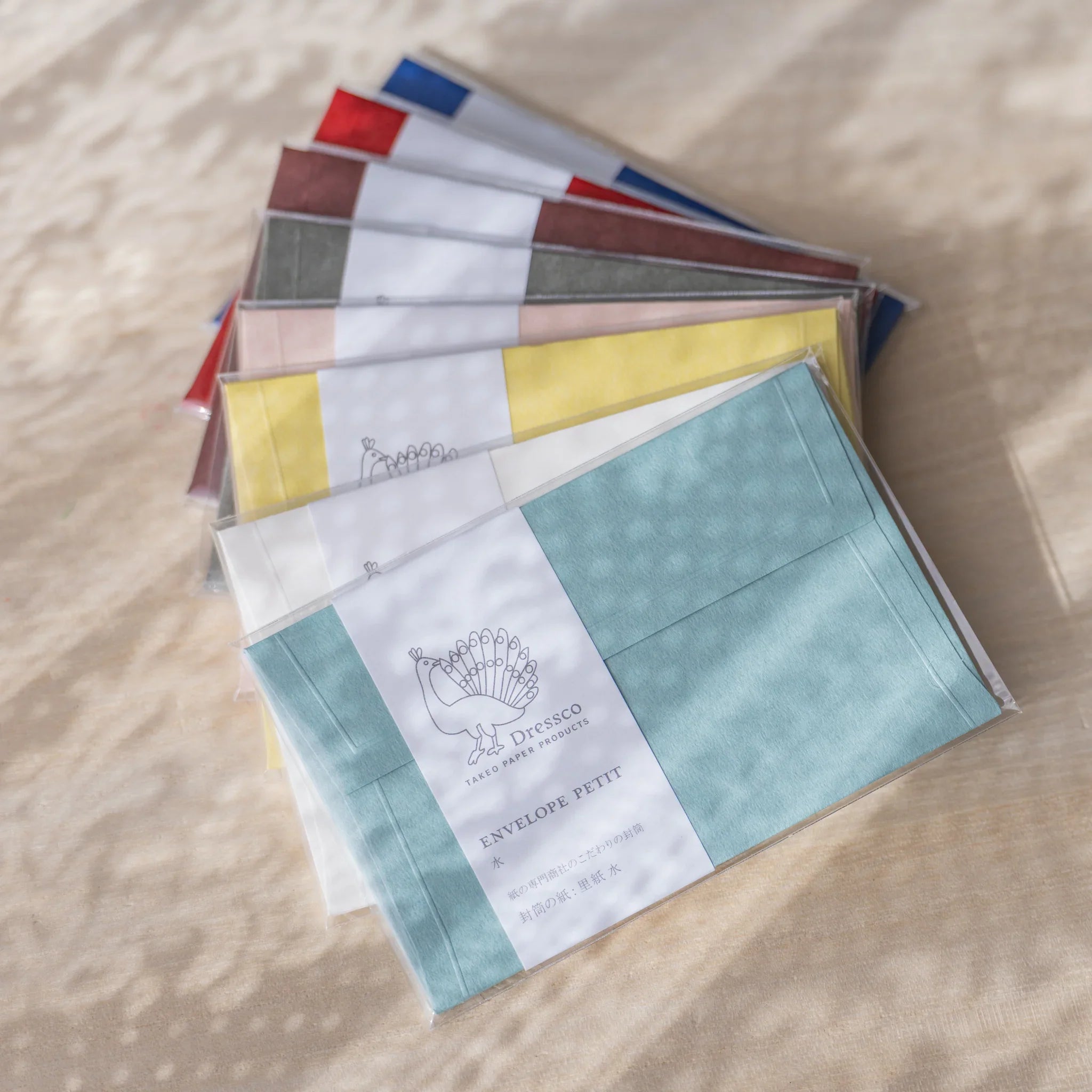 Dressco embossed small envelope in sage green, flat lay showing textured surface