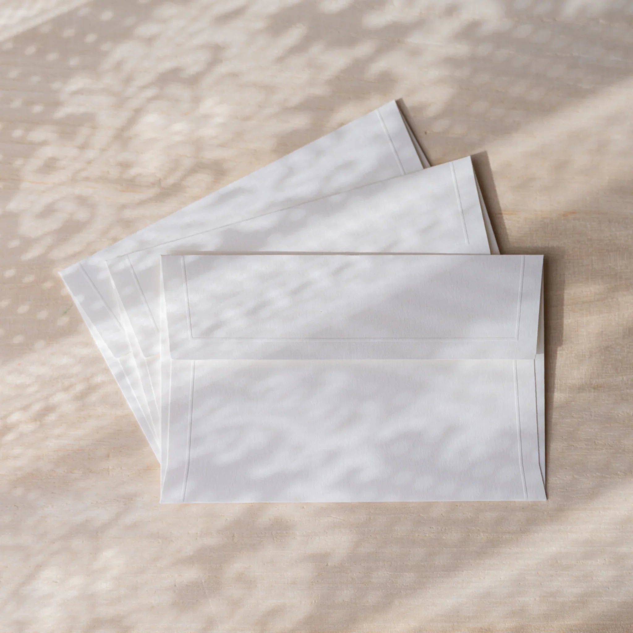 Dressco small embossed envelope set, sage green shade, flat lay showing with tex