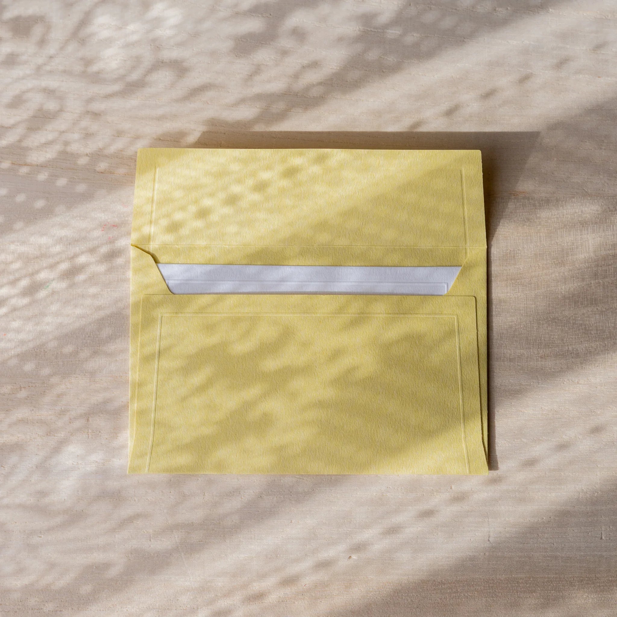 Dressco small embossed envelope set, teal shade, flat lay showing with subtle te